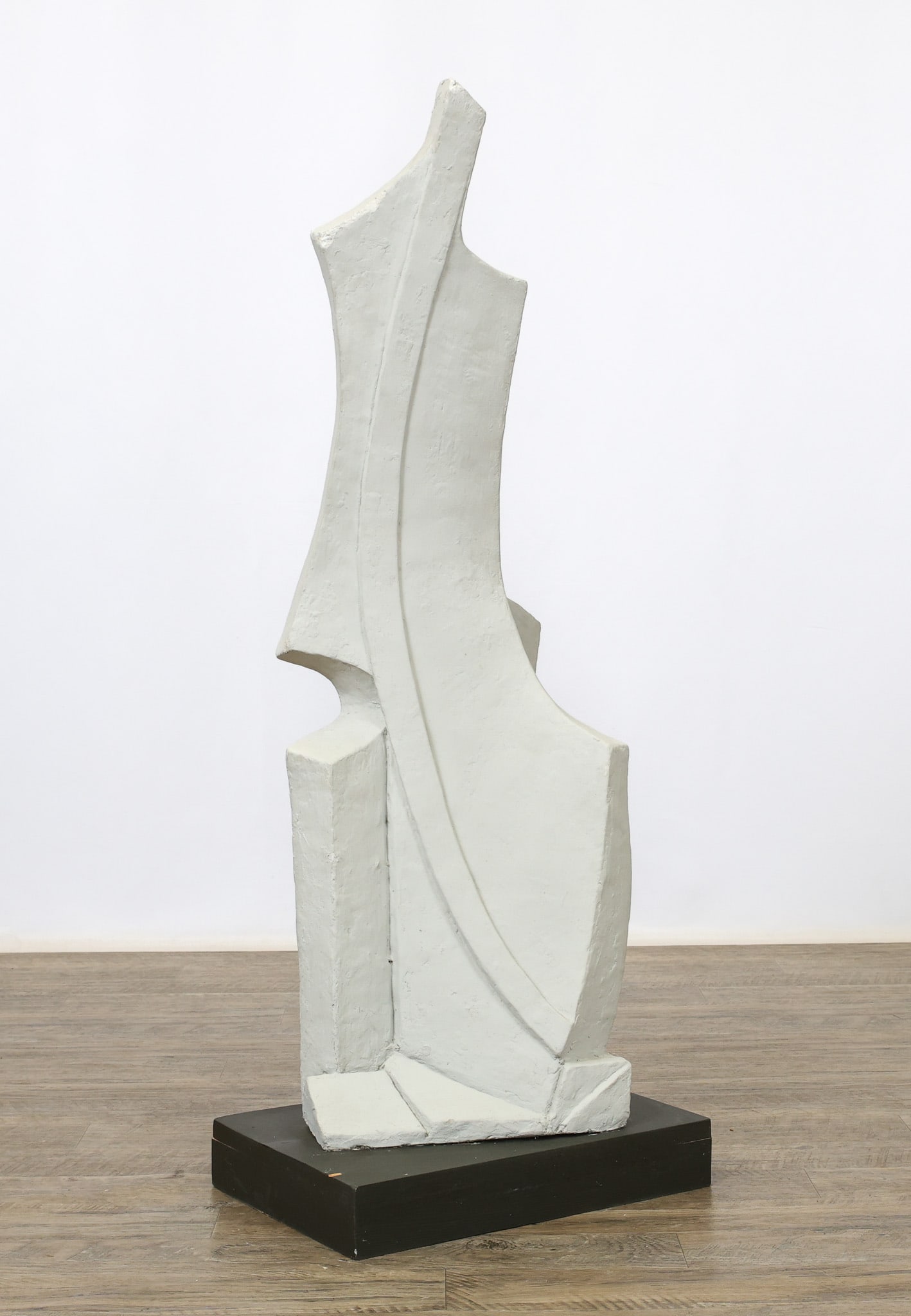 Abstract Expressionist Sculpture: Plaster sculpture, an abstract expressionist composition, mounted to a black wooden plinth. Unsigned. 44"h x 16.5"w x 11"d