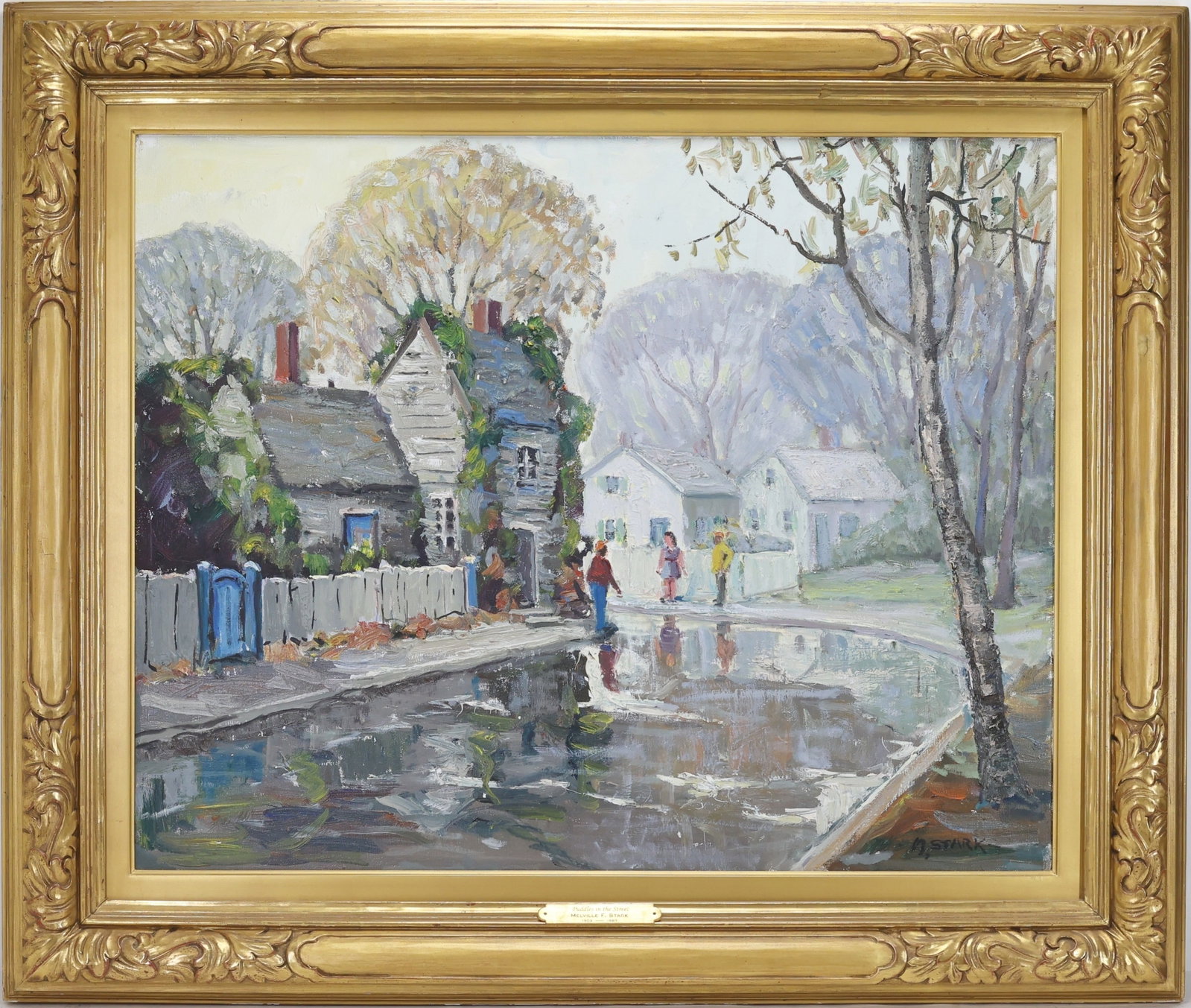 Melville F. Stark (1903 - 1987) in Newcomb Macklin Frame: Oil on canvas, SLR. Impressionist street scene with cottages, figures standing near puddled roadway, white fences, and autumn trees. Canvas measures 24”h x 30”w and housed in Newcomb