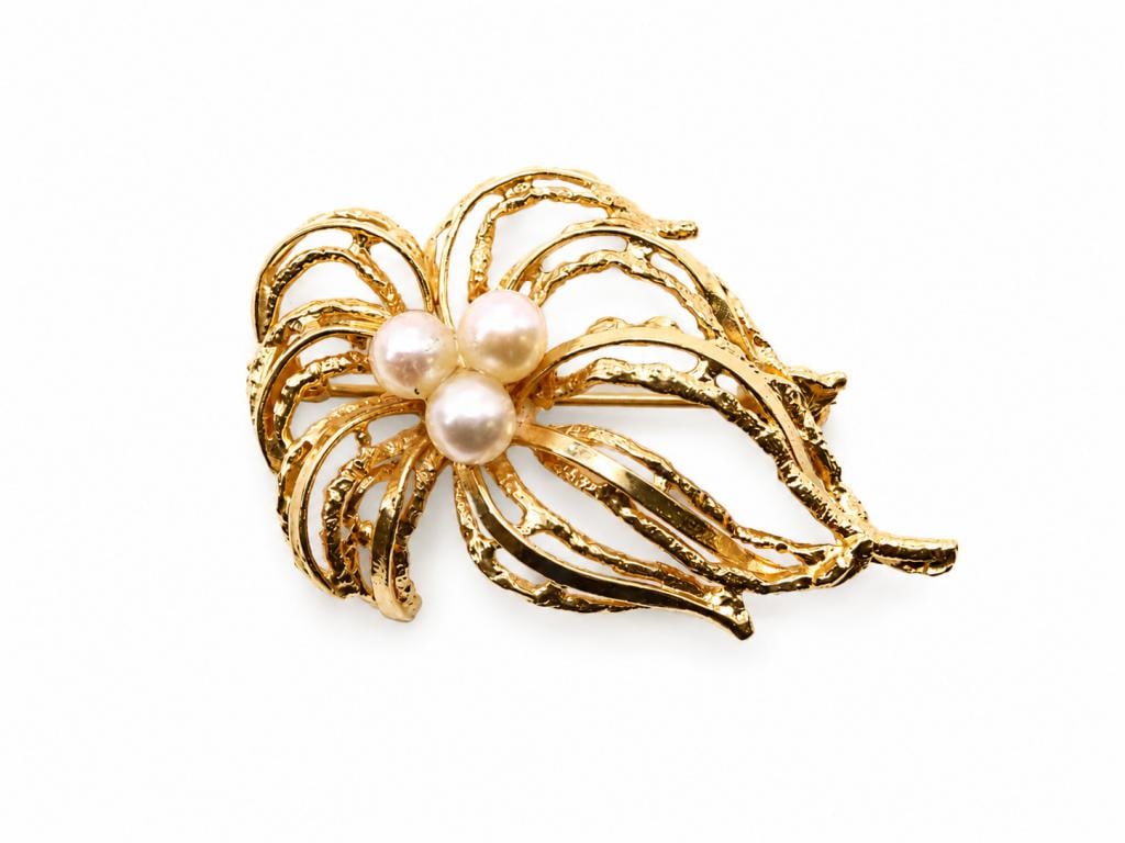 14k YG Pearl Brooch: 14K yellow gold cultured pearl brooch, designed as an abstract foliate spray with textured openwork leaves. 1.5" and 3.9 dwt.