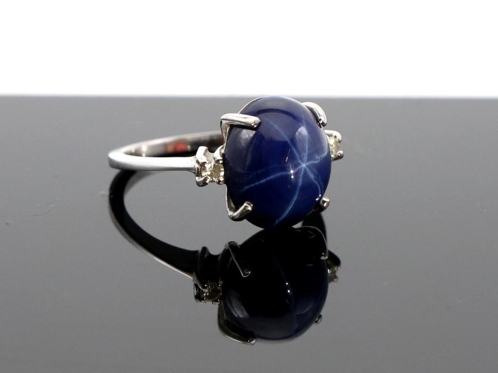 14k WG Star Sapphire RIng: 14K white gold ring set with an oval cabochon star sapphire measuring approximately 11.9 mm, accented by two round diamonds. Size 5.75, 2.9 dwt.