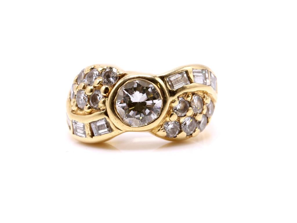 18k YG Diamond Ring: 18K gold diamond ring, bezel set with one round brilliant cut diamond weighing approximately 1.00 carat, accented by approximately 1.00 carat total weight of round brilliant cut diamonds and approxima