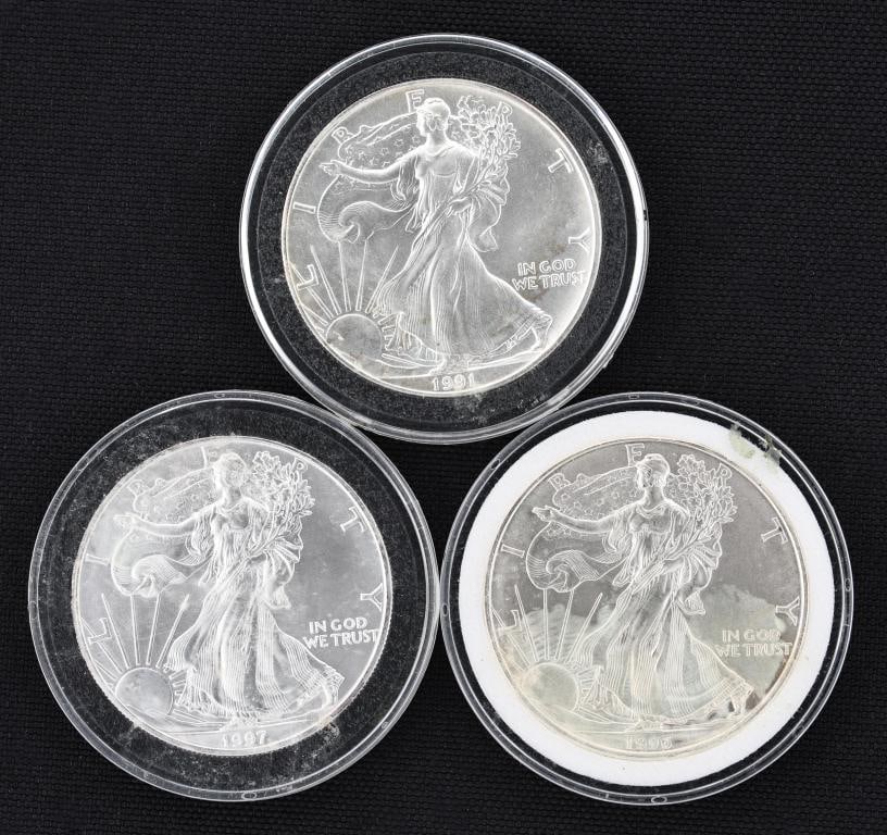 American Silver Eagle Dollar Coins: US uncirculated fine silver dollar coins, 1991, 1996, 1997. (3) coins. 40.6 mm and approx. 1.0 ozt, approx. 3 ozt overall