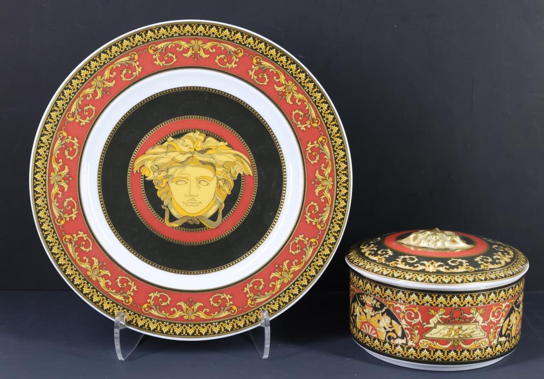 Rosenthal - Versace "Medusa Red" Porcelain Tablewares: Designer porcelain pieces decorated with Neoclassical motifs and, the Versace Medusa mask logo, including a bread & butter plate, and a covered box featuring the Medusa mask in relief. (2) pieces.