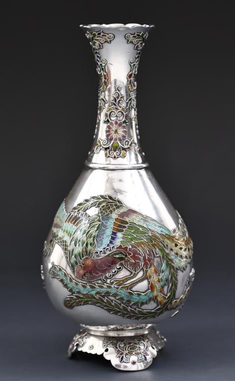 Japanese Enameled Silver Vase: Meiji era silver vase with cloisonne enameled decoration depicting a phoenix and floral motifs, with a scalloped rim, raised on ruyi form bracket feet. Unsigned. There is a French silver import mark t