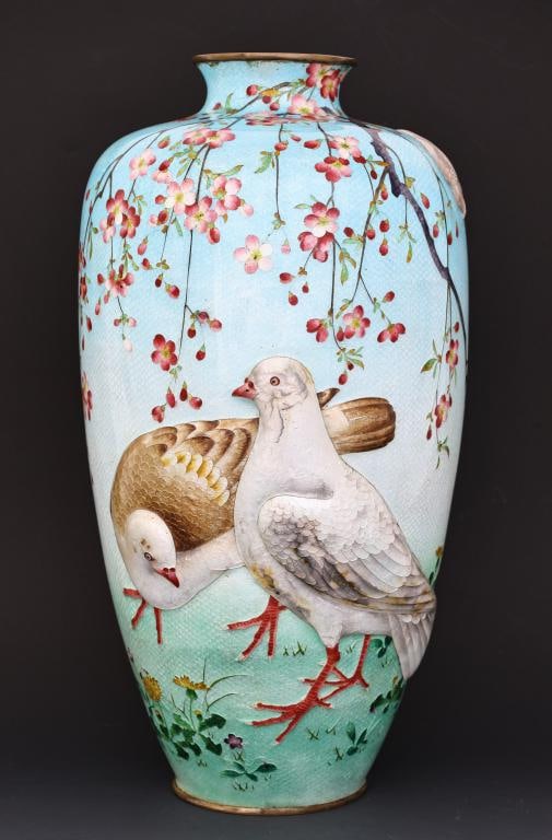 Japanese Tsuiki-Jippo and Ginbari Cloisonne Vase: Meiji - Taisho tsuiki-jippo and ginbari silver wire cloisonne vase depicting doves among cherry blossoms on a gradient blue-green ground. Unmarked. Areas of discoloration; some enamel damage to the do