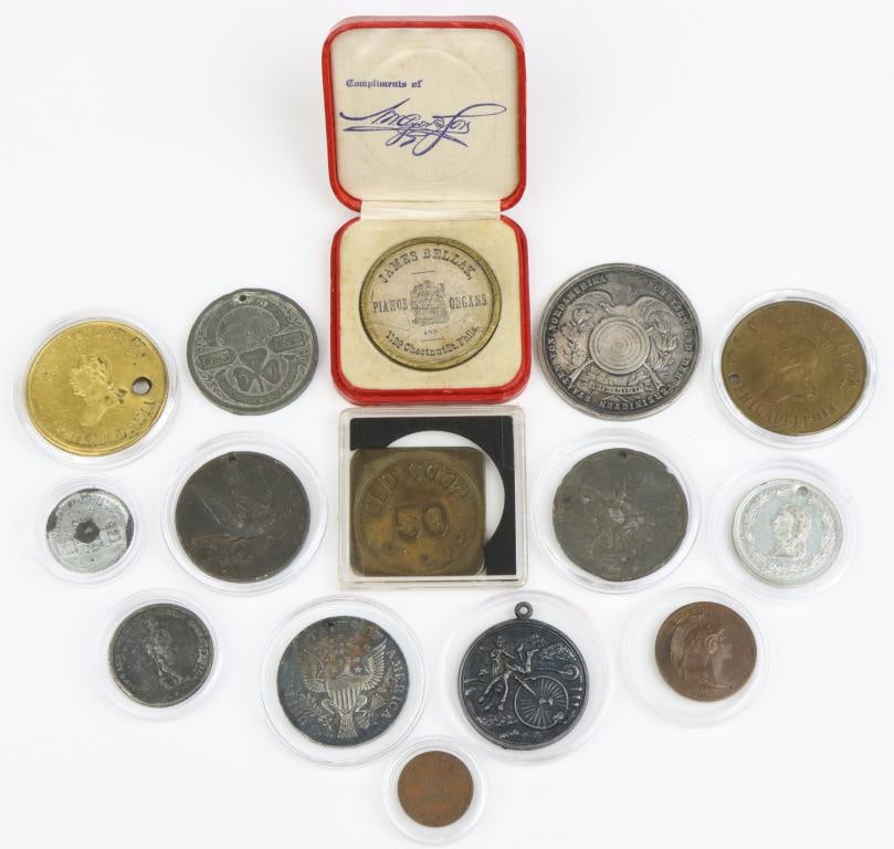 Late 19th Century/Early 20th Century Philadelphia Trade Tokens & Commemorative Medals: Collection of 15 Philadelphia trade tokens including; 1.) A.C. Yates, Clothiers, 6th & Chestnut Sts. Token presents full length portrait of well dressed gentleman on reverse, is white metal and