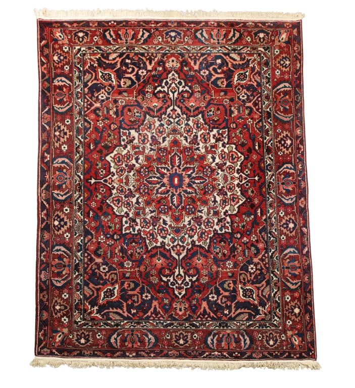 Persian Bakhtiari Rug: Hand knotted having a cloud collar pole medallion with an all over stylized floral and meandering vine field and spandrels, and an alternating palmette cartouche and leaf main border in multi-colors o
