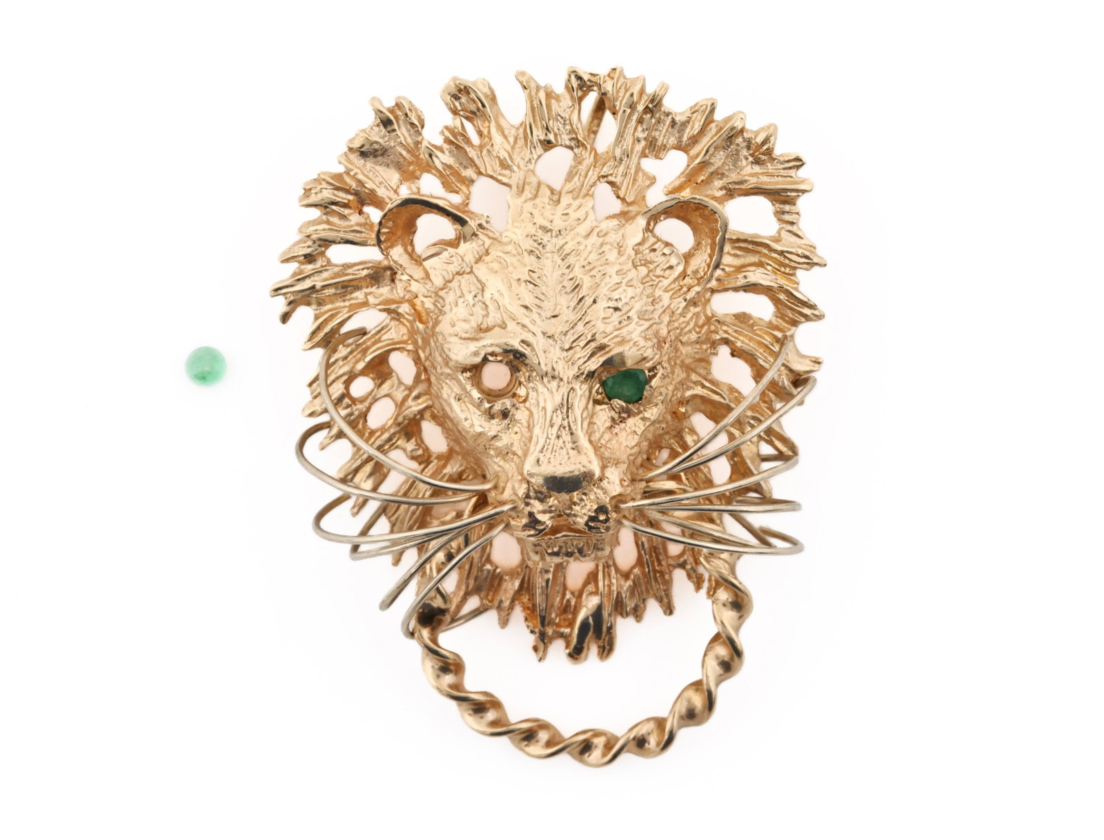 14k YG Emerald Pendant: 14K yellow gold lion head door knocker pendant with emerald eyes and wire whiskers. One emerald eye loose but included. 1.5"h. 6.3 dwt.
