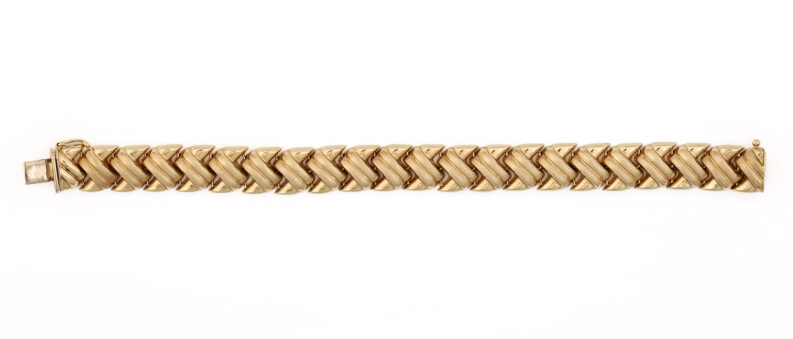 14k YG Bracelet: 14K yellow gold bracelet with interlocking textured and polished links, box clasp and safety catch. 7.25"l. 12.5 dwt.