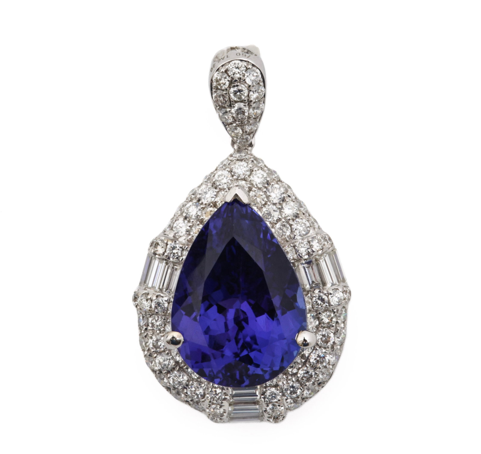 18k WG Tanzanite Diamond Pendant: 18K white gold pendant with an approximately 6.50 ct pear shape tanzanite surrounded by approx. 1.00 ctw round and baguette cut diamond accents. 1"h. 3.3 dwt.