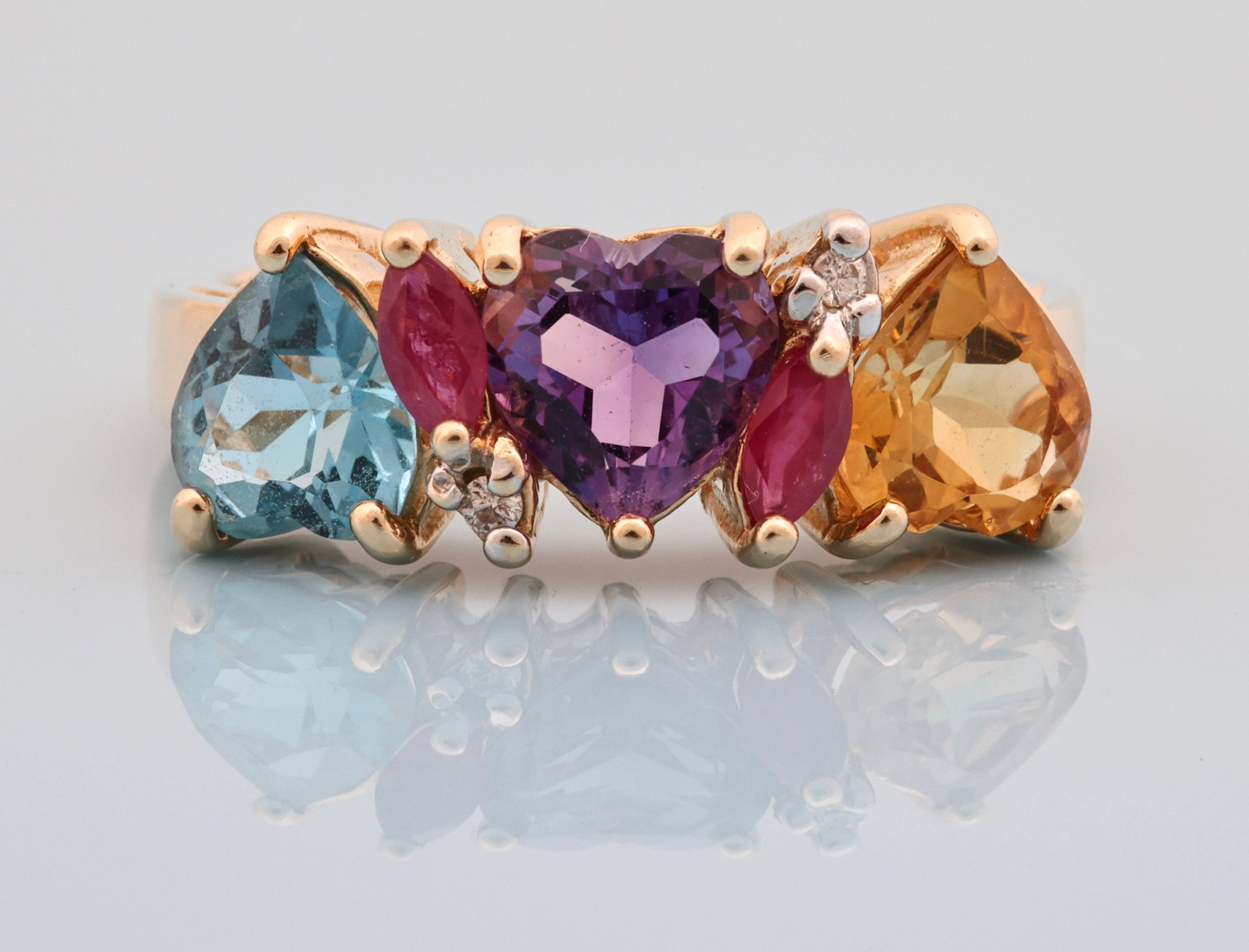 14K YG Gemstone Ring: 14K yellow gold ring with three approx. 5.5mm heart shaped citrine, amethyst, and blue topaz, with marquise cut ruby and round brilliant cut diamond accents. Size 5.75 and 2.3 dwt.