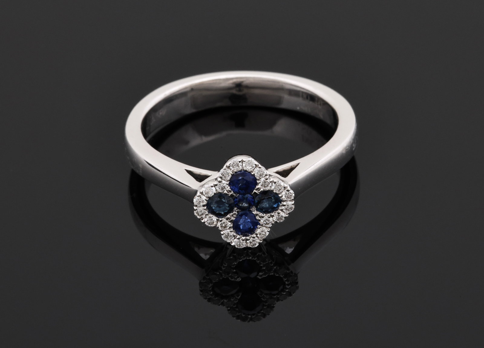 14K WG Sapphire & Diamond Ring: 14K white gold ring with approx. 0.25 ctw round cut blue sapphires surrounded by approx. 0.10 ctw round brilliant cut diamond accents. Size 5.25 and 2.3 dwt.