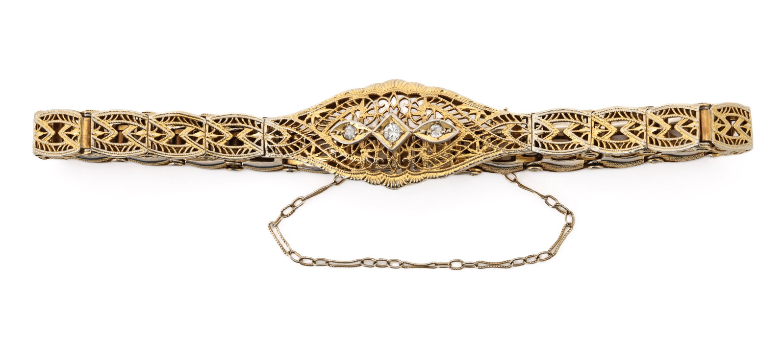 14k YG/WG Bracelet: 14K white and yellow gold Art Deco filigree bracelet with openwork links and three diamond accents. 7"l and 5.7 dwt.