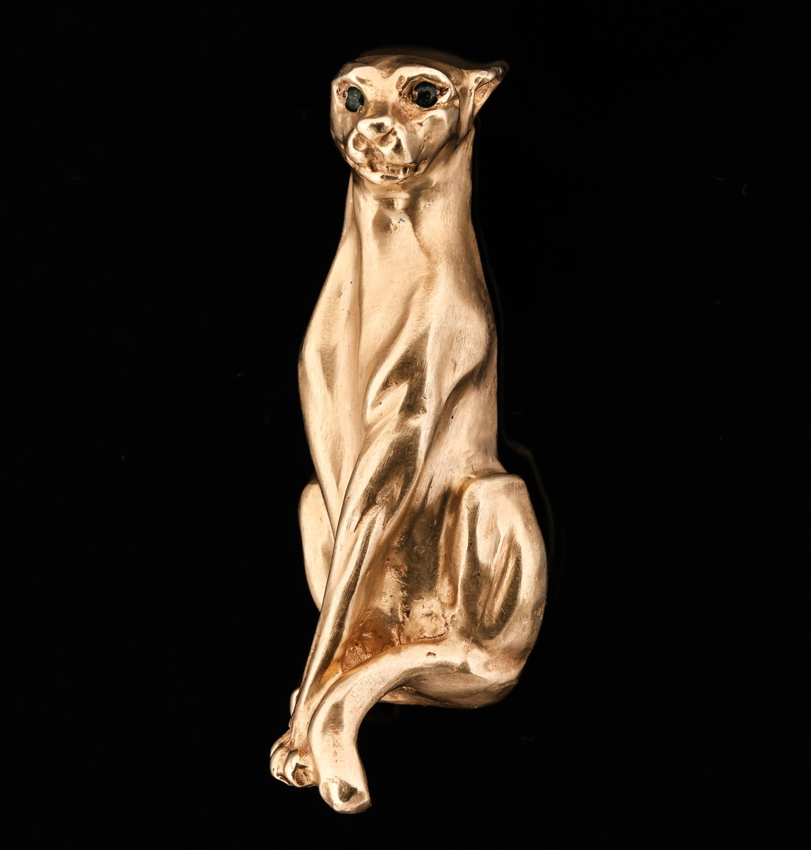 14k YG Brooch: 14K yellow gold panther brooch with emerald eyes. 2"h. 12.7 dwt.