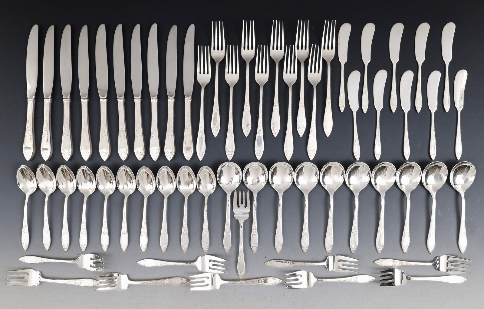 Stieff "Lady Claire Engraved" Sterling Silver Flatware Service for 10: American sterling silver service, including 7.25" dinner forks, 9" knives, salad forks, soup spoons, teaspoons, and butter spreaders. (60) pieces. 59.38 ozt excluding hollow handle pieces