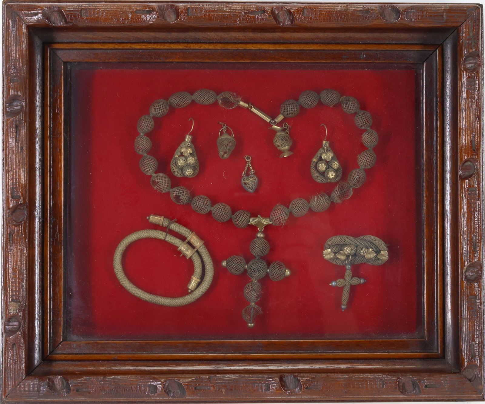 Victorian Mourning Jewelry Suite: Victorian mourning jewelry suite with woven hair necklace, bracelets, earrings, brooch and pendants, mounted with gold tone fittings and floral accents. Loss noted. Presented in a carved wood