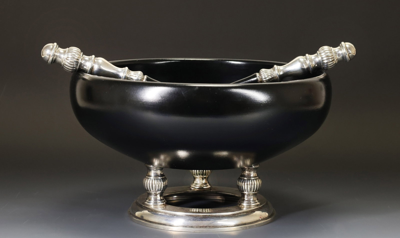 Hallmark Sterling Silver and Wood Salad Bowl and Servers: American sterling silver and ebonized wood salad bowl and two-piece serving set with gadrooning. Some surface wear from use. (3) pieces. Bowl 6.25"h x 10.5"w, servers 11"