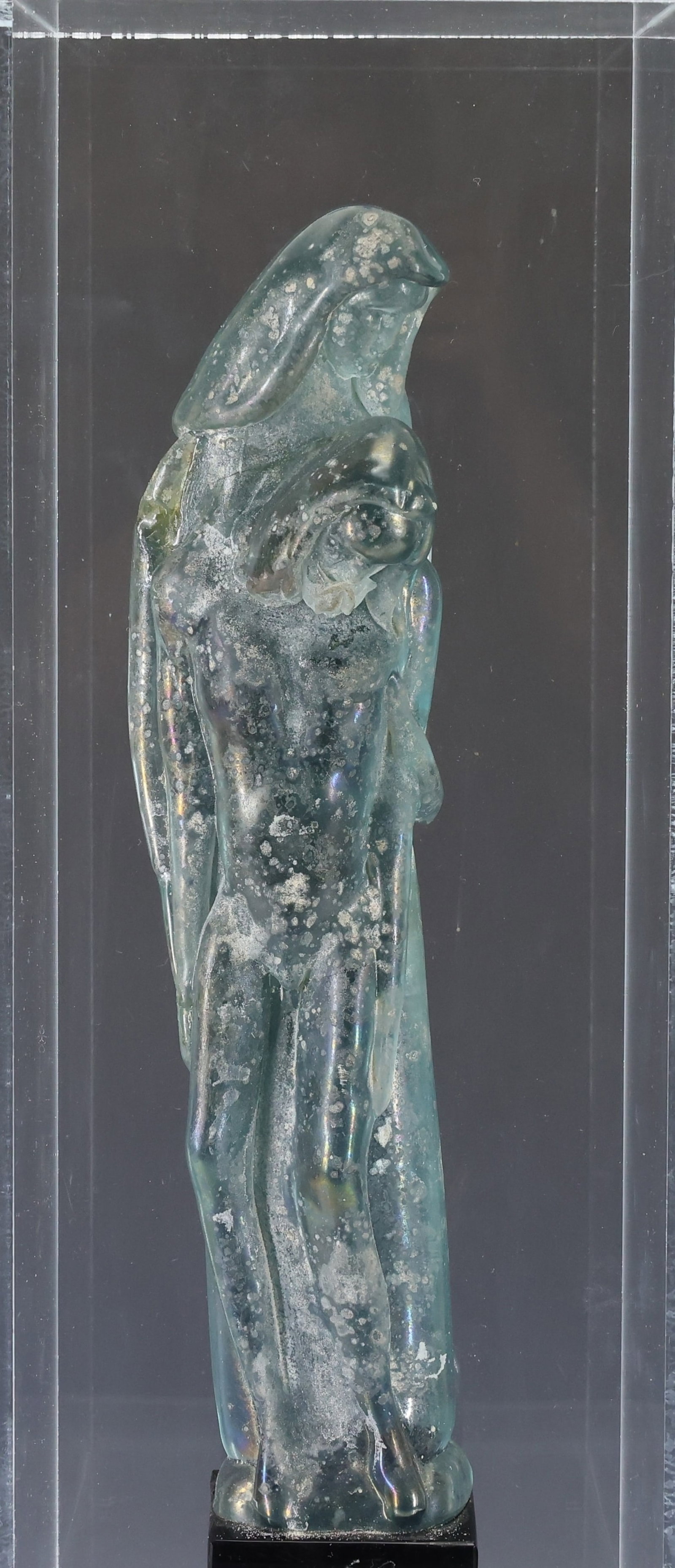 Ermanno Nason (1928 - 2013): Vecchia Murano glass Pieta sculpture, a depiction of Mary and Jesus, iridescent sky blue, made using the scavo and massello techniques, rising from a black plinth, with etched signature to the