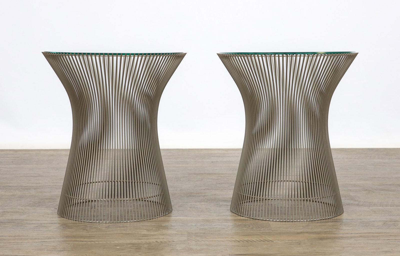 Warren Platner for Knoll Side Tables: Steel wire pair of drum form side tables with inset round glass tops. One of the glass tops shows several chips to the edge. (2) tables. 18"h x 15"w