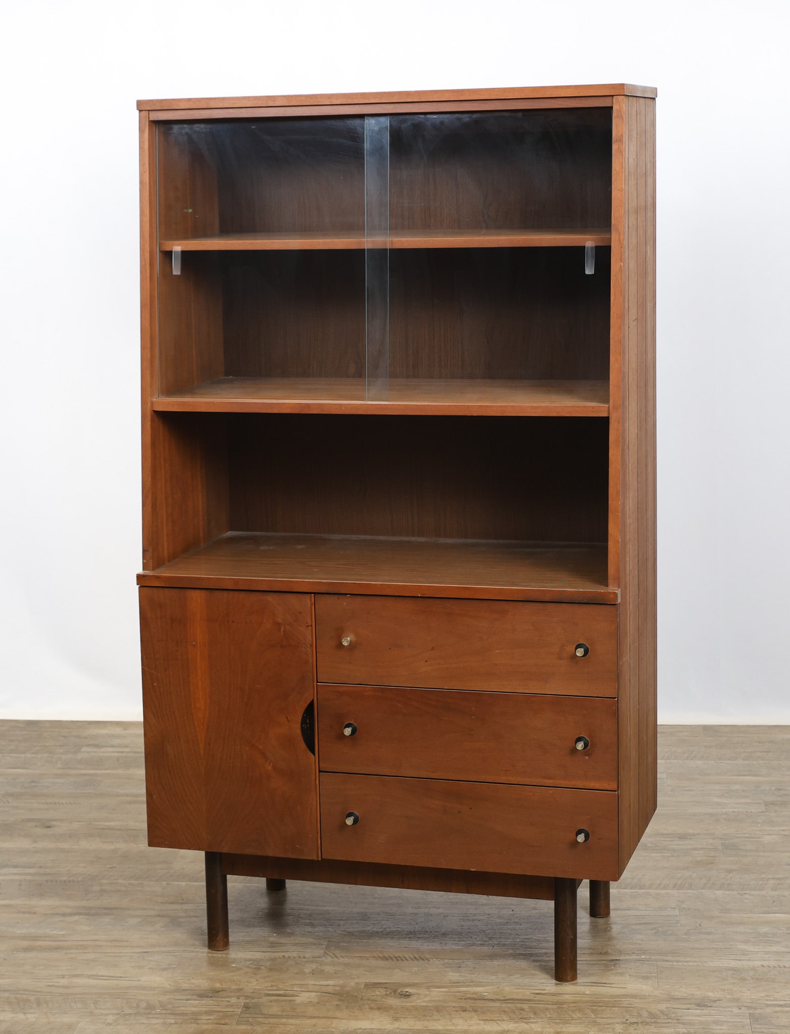 Distinctive Furniture by Stanley Buffet Hutch: Walnut hutch with shelving behind sliding glass doors over an open cubby over three drawers, one fitted for flatware, and a cabinet with shelving, featuring a tapered profile and fluted sides, all
