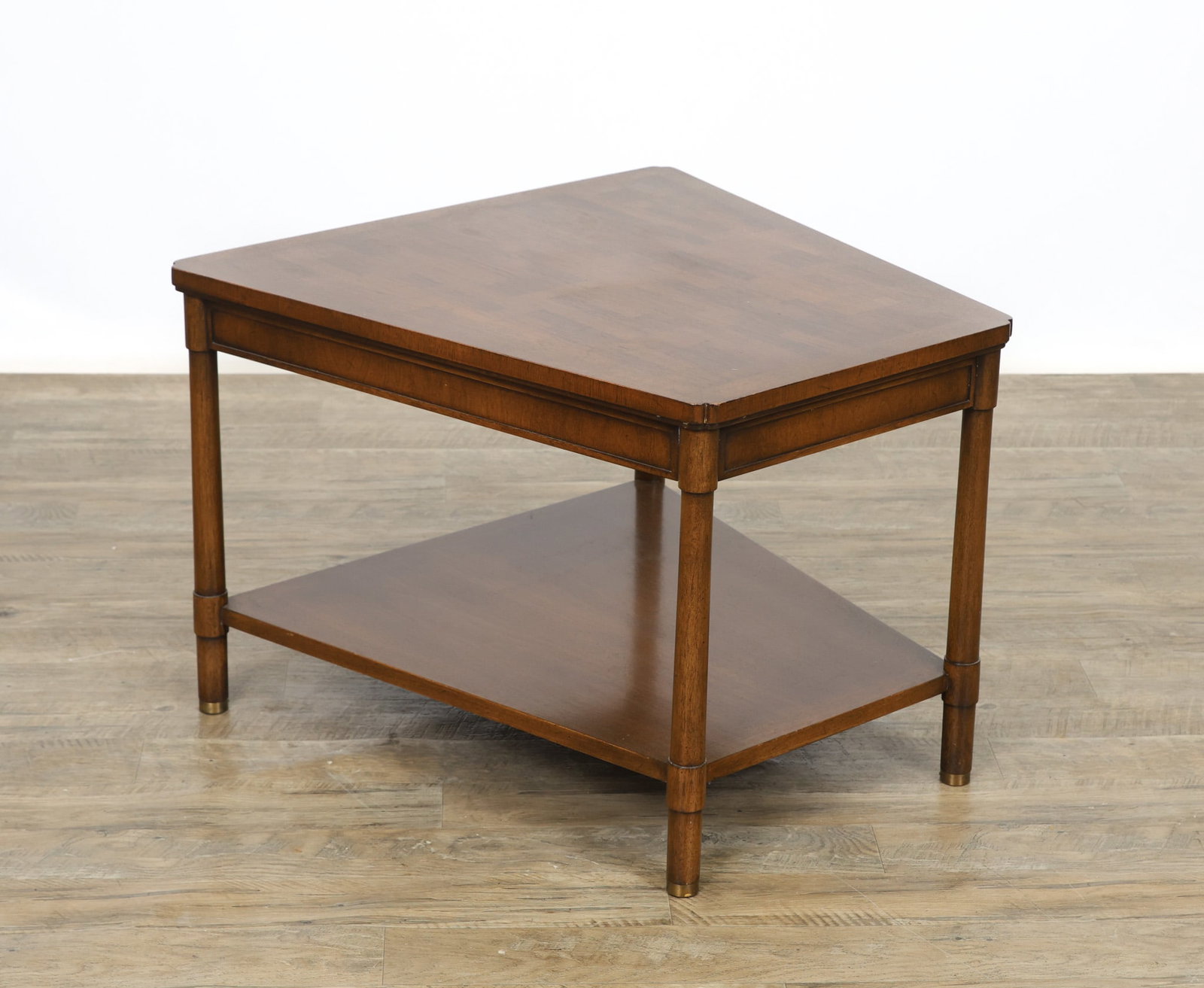 Bert England for Johnson Furniture Wedge Table: Walnut wedge side table with two tiers featuring parquetry and crossbanding, raised on straight round supports with brass sabots. Part of the the "Forward Trend" collection. Labeled to the underside.