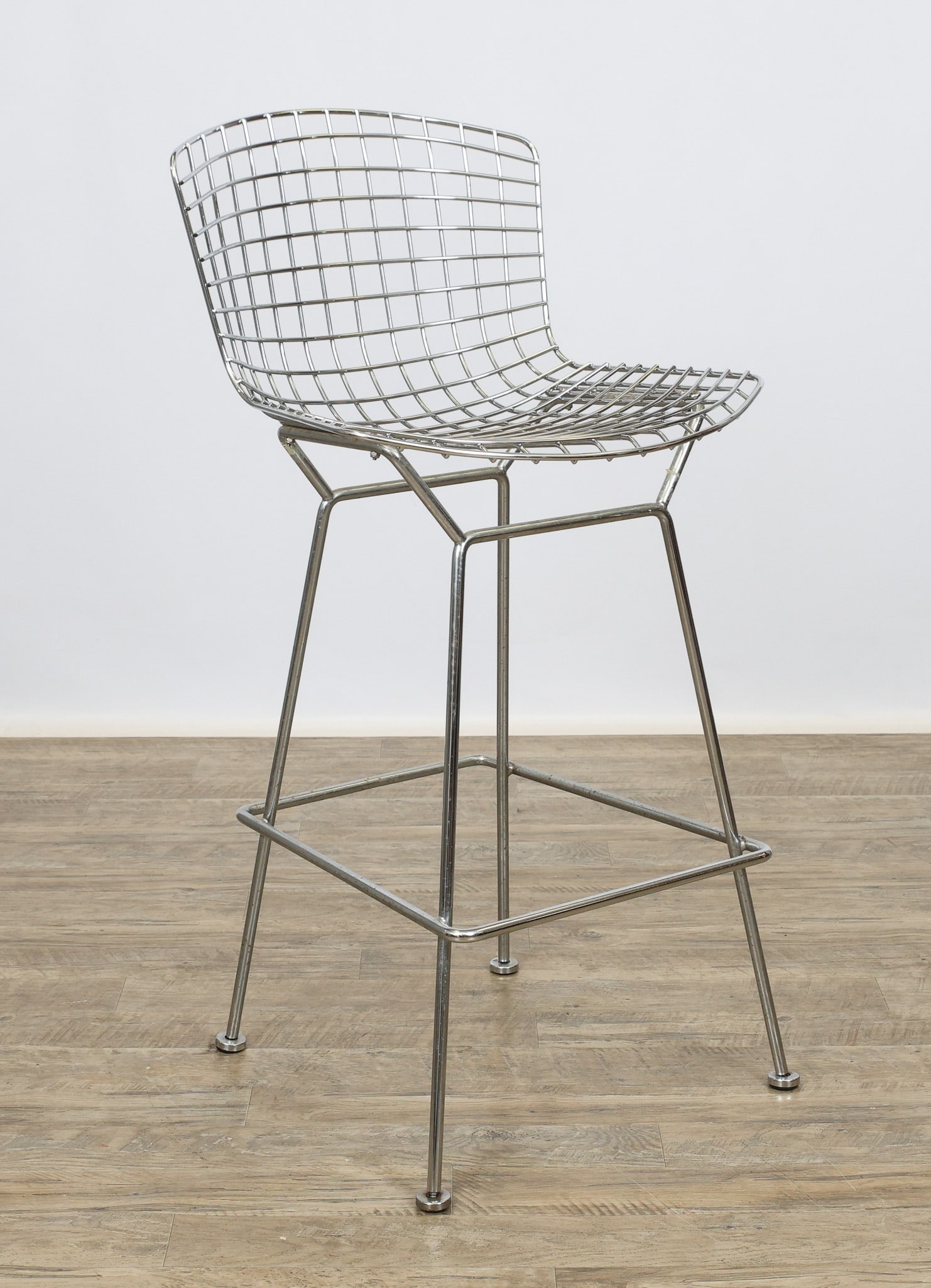 Knoll Bertoia Bar Stool: Wire stool in chrome with a tubular steel base. Marked for Knoll. Scattered pitting. 41"h x 21"w x 18.5"d, 29" seat height