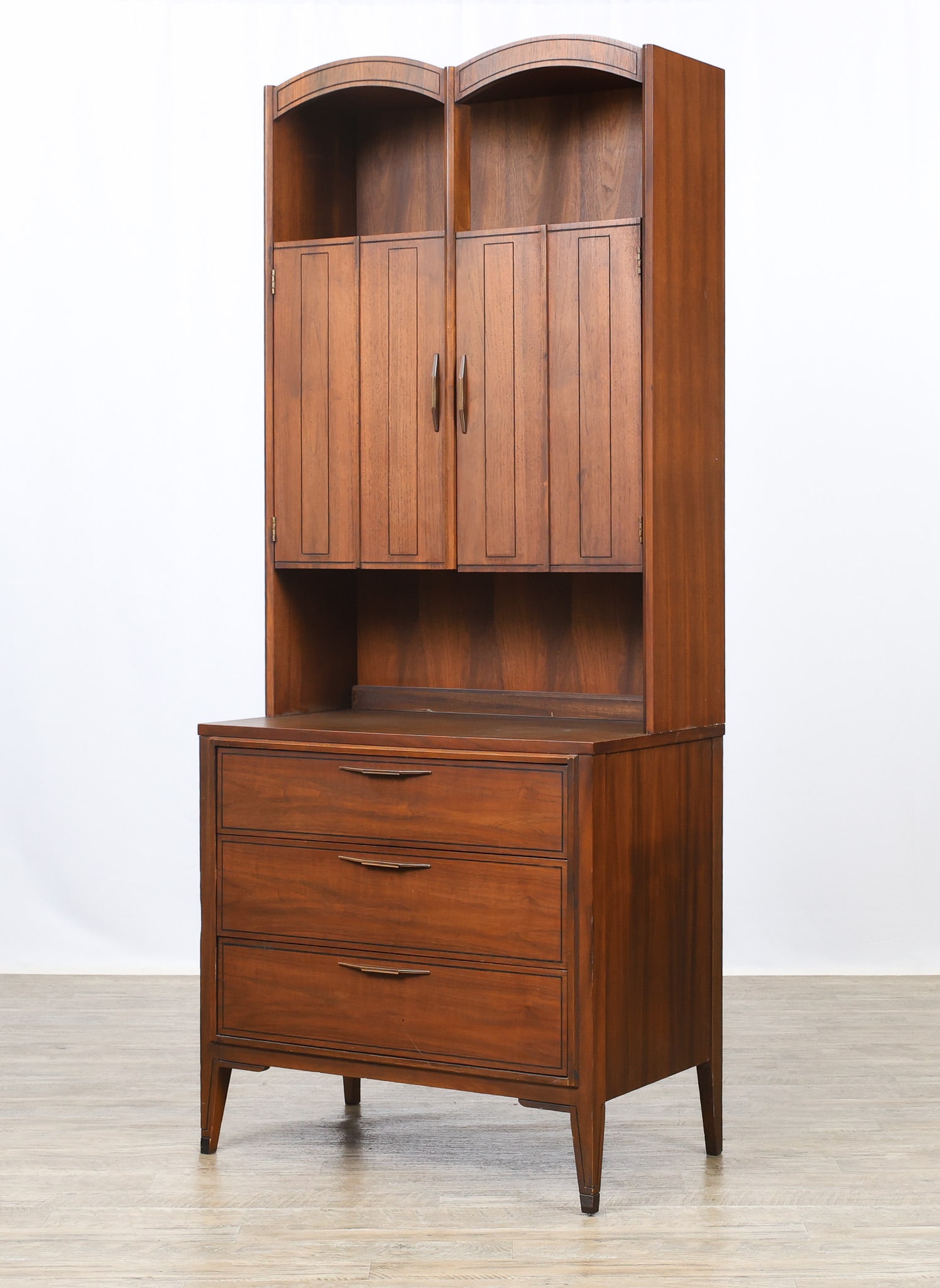 Kent Coffey "Tempo" Hutch: Walnut and elm hutch, the lower part a three drawer chest with a laminate top, raised on shaped and splayed legs, model no. 7974, and the upper part features open shelving and two doors which open to