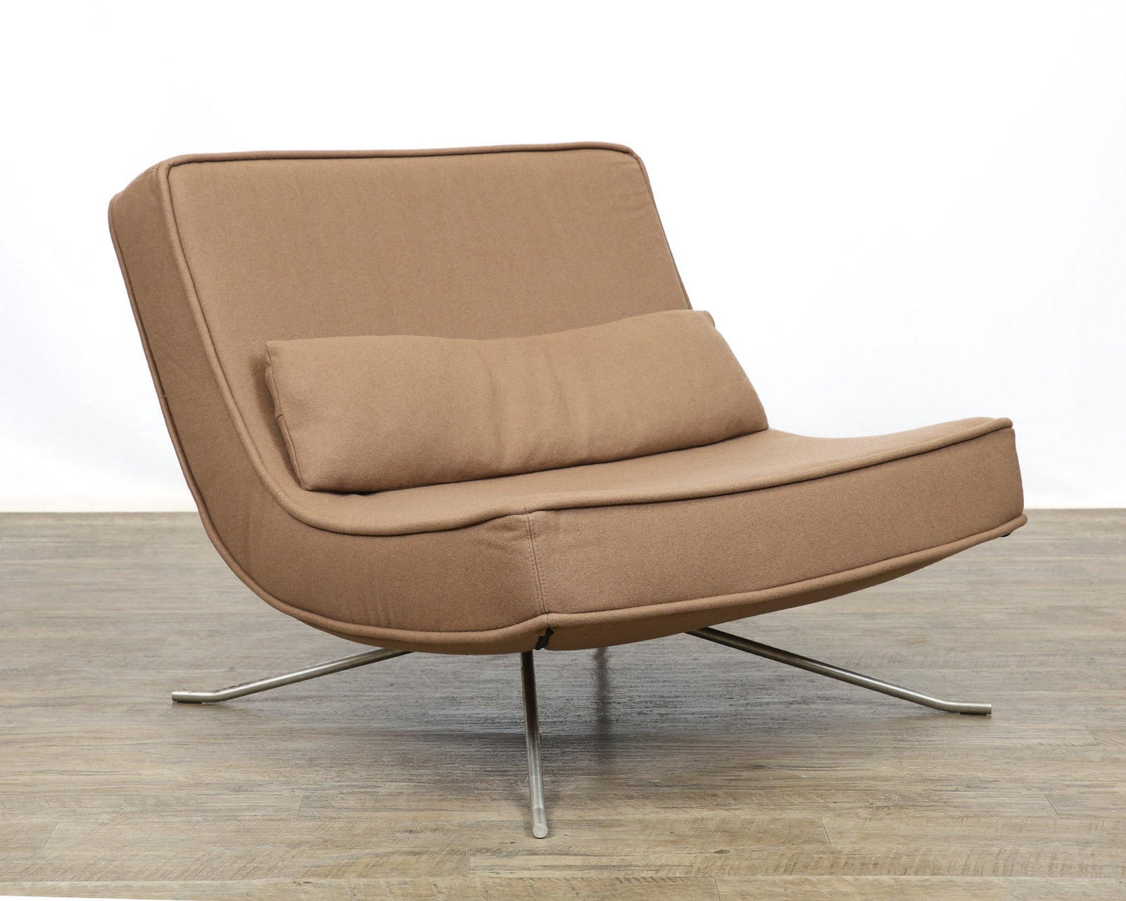 Christian Werner for Ligne Roset "Pop" Lounge Chair: French Modern oversized scoop lounge chair with beige upholstery and matching lumbar pillow, raised on a flared brushed aluminum four-star base. Labeled. 29"h x 36"w x 36"d, 16"seat height