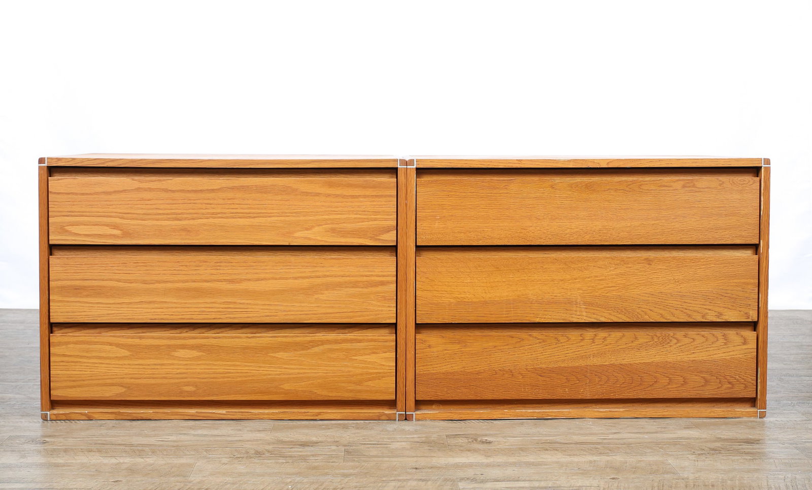 Barzilay Modular Chests of Drawers: Oak chests no. 3030, each with three drawers, and featuring aluminum trim. Includes four mounting rails. Labeled. (2) chests. 23"h x 31.5"w x 19"d