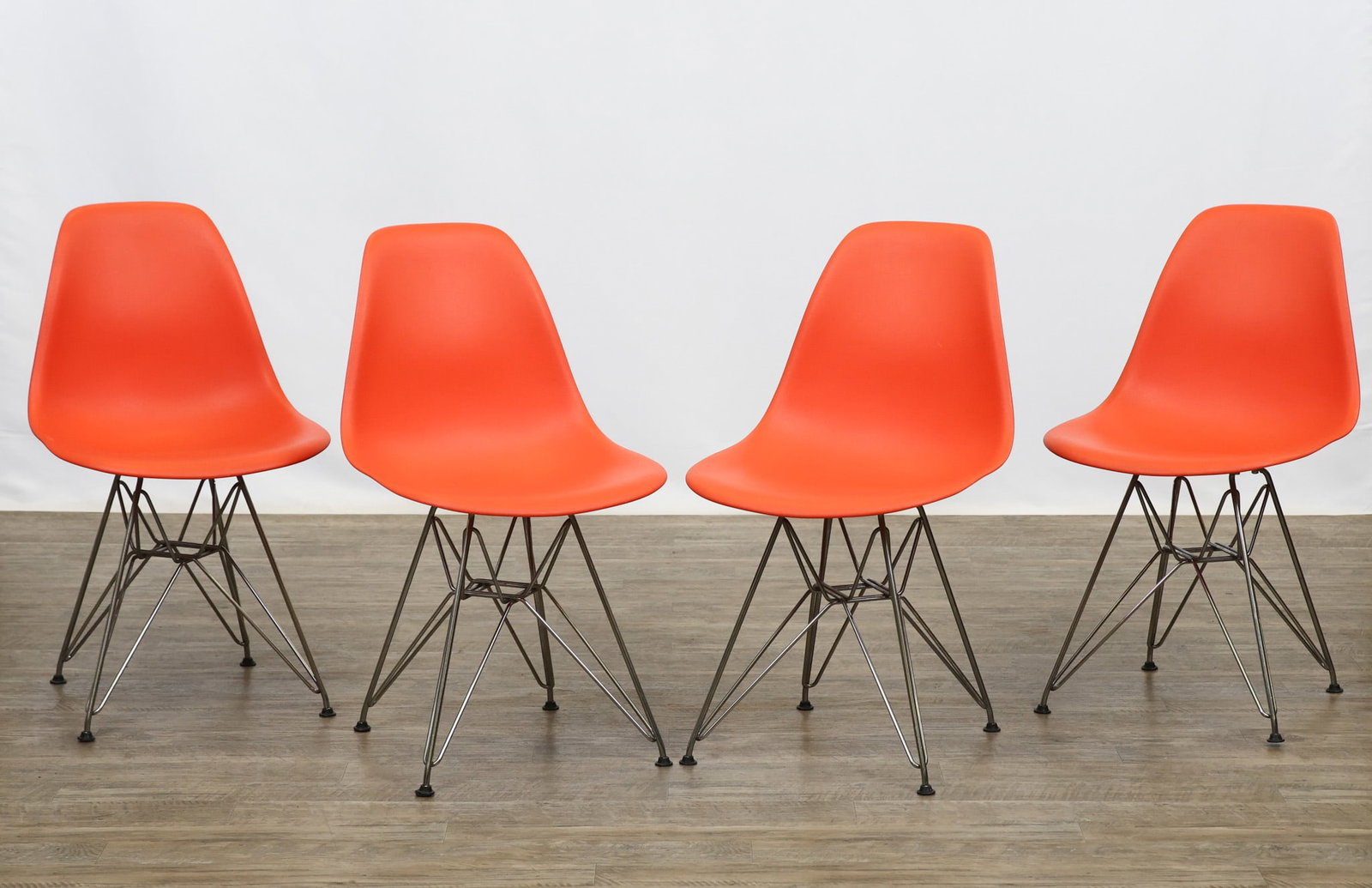 Herman Miller / Eames Office Molded Plastic Shell Chairs: Shell side chairs in a red-orange finish with chrome finished wire bases. Marked in the mold. Set of (4). 32"h x 18"w x 16"d, 17"seat height