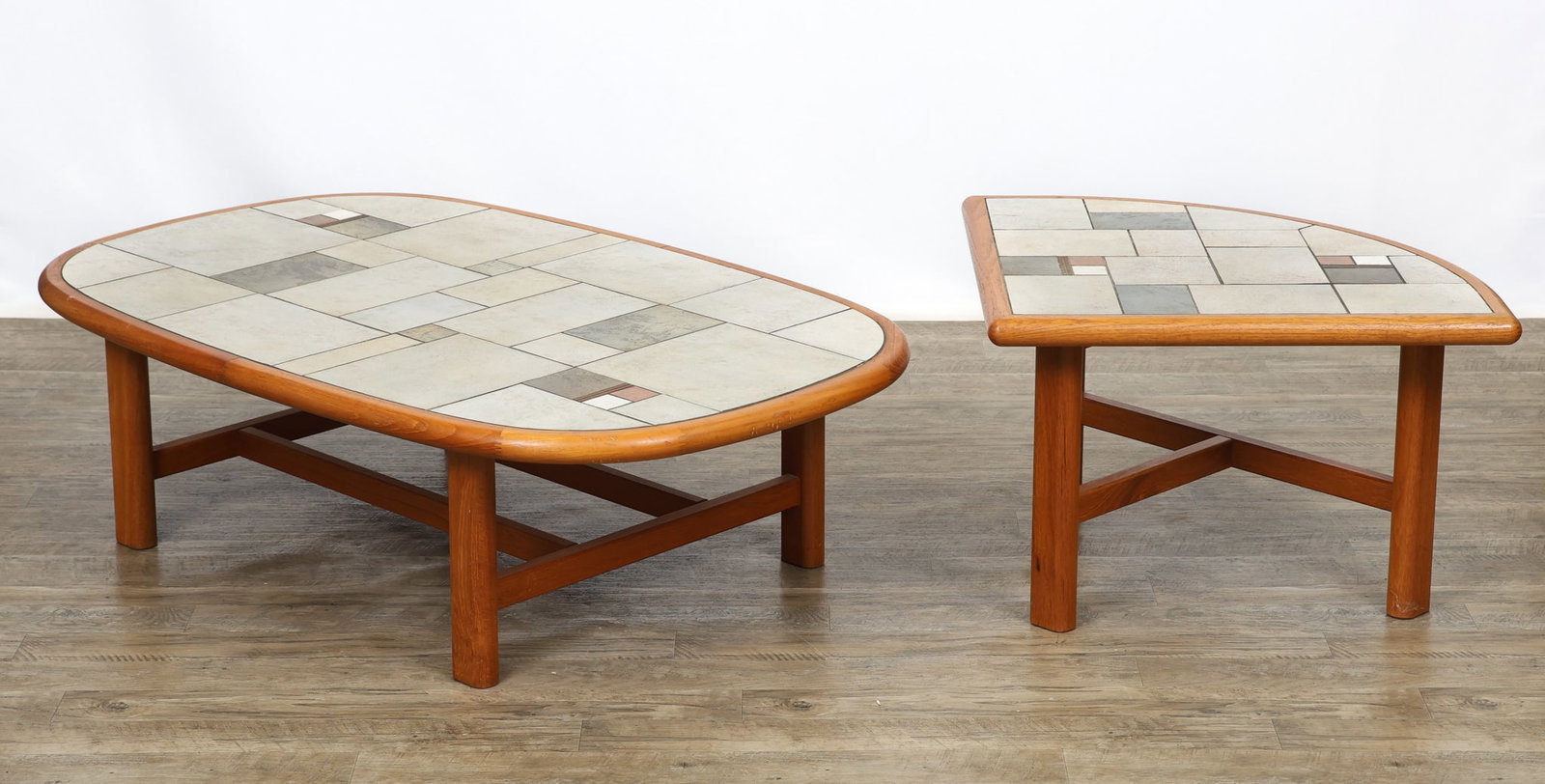 Gangso Tile Top Teak Coffee and Side Tables: Danish Modern teak oval coffee tale and wedge side table with inset mosaic tile tops, featuring rounded edges, and raised on shaped legs with straight square stretchers. The side table is labeled.
