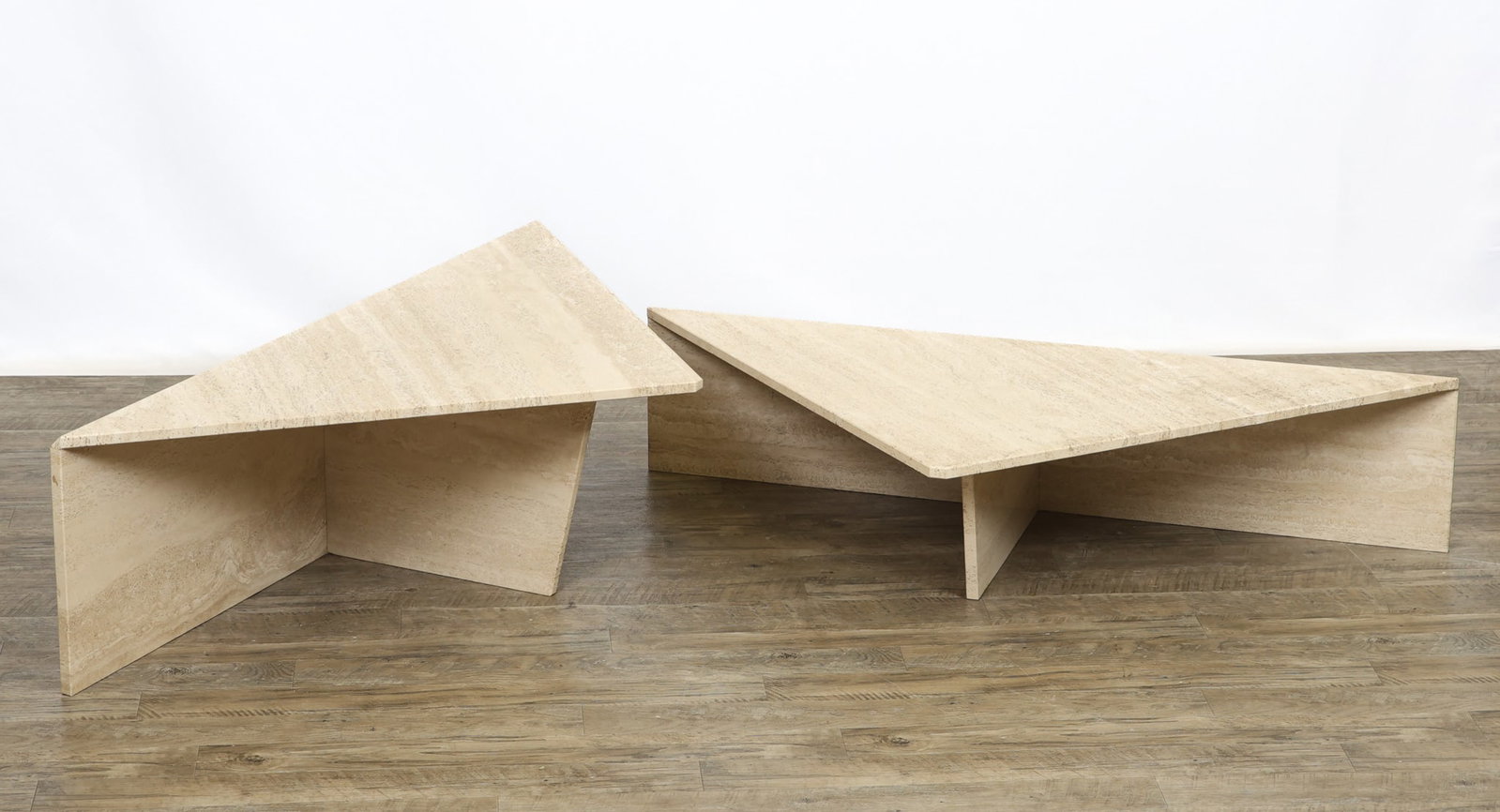 Travertine Two-Piece Coffee Table: Italian Postmodern two-piece coffee table, each triangular piece of different heights, with beveled and chamfered edges and cut corners. Can be arranged in various configurations. Attributed to