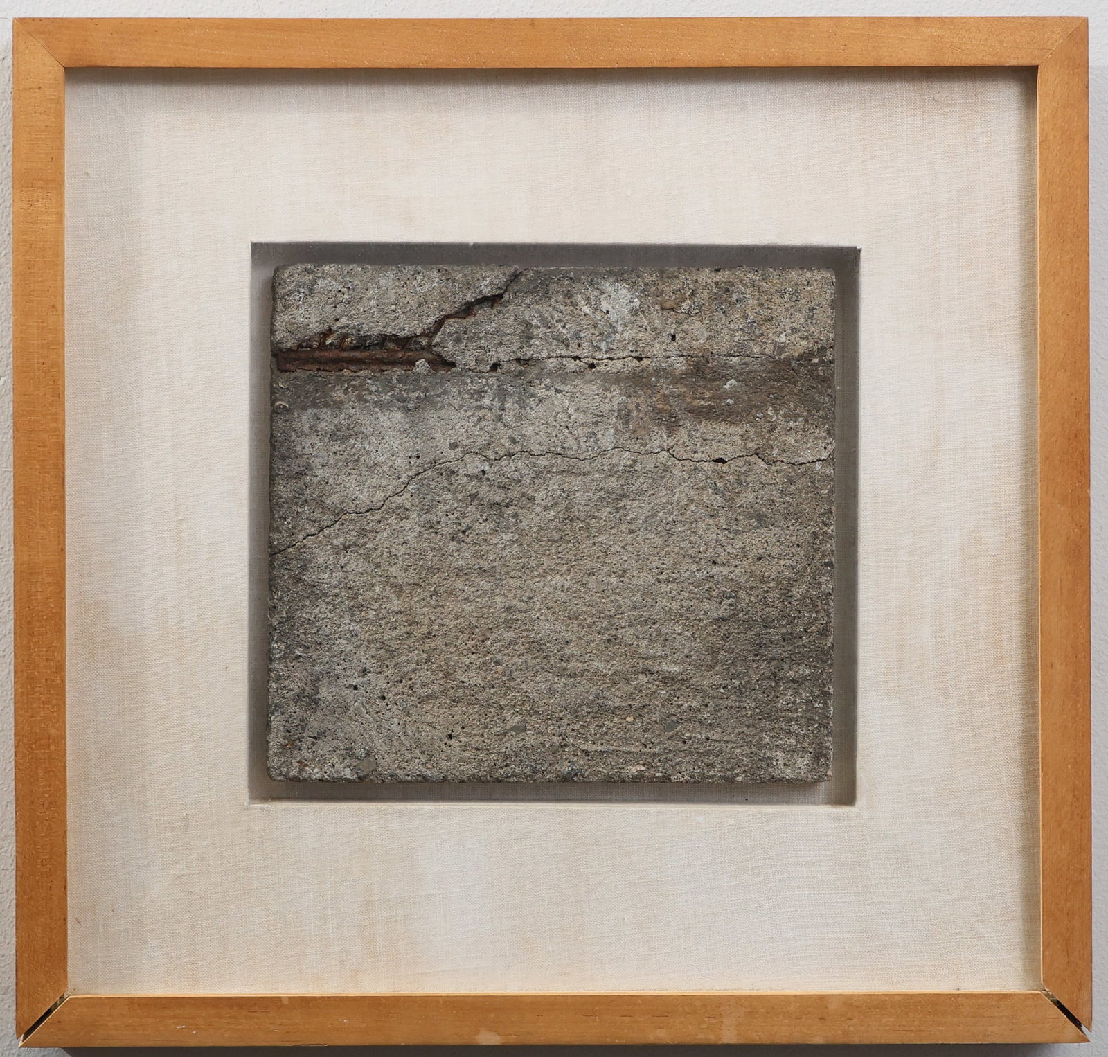 Julius Tobias (1915 - 1999): Found art sculpture made from a concrete and rebar slab mounted in a shadowbox frame, "Any Piece of Nothing Looks Good When Framed Properly", dated 1975, stamped to the frame en verso. Overall 16.5"h