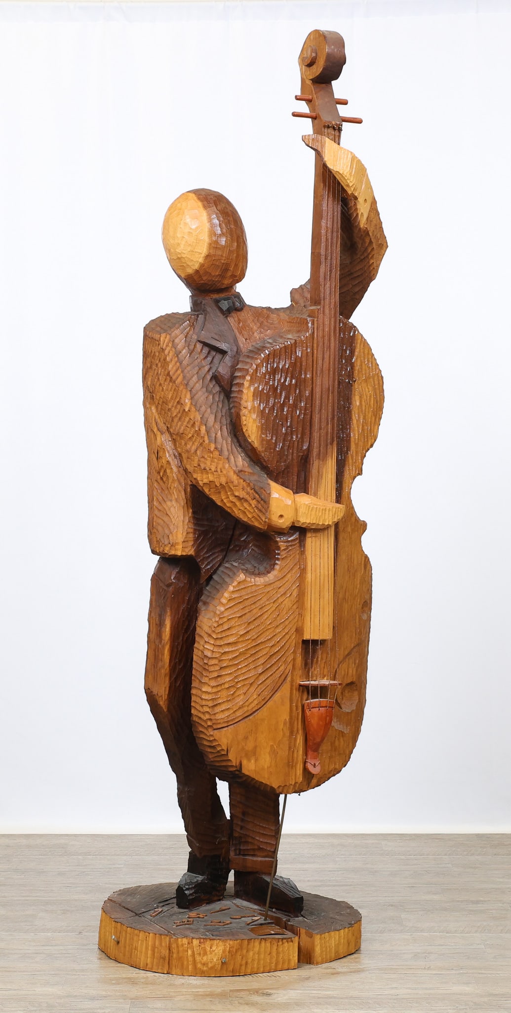 Pinuccio DeRosas (Contemp.): Life sized carved ash wood sculpture by Sardinian artist Pinuccio DeRosas, "Il Contrabbassista (The Contrabassist)", an Expressionist depiction of a man playing the double bass, featuring strings