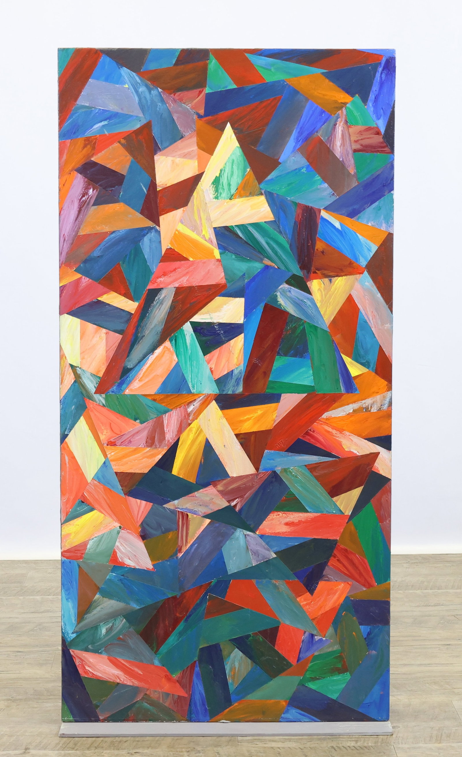 Dennis Will (20th/21st c.): Painted wood plinth base supporting upright fiberboard having a surface collaged with shaded strips of color fitted with triangular shapes, giving a dimensional appearance. 48"h x 24"w x 7"d