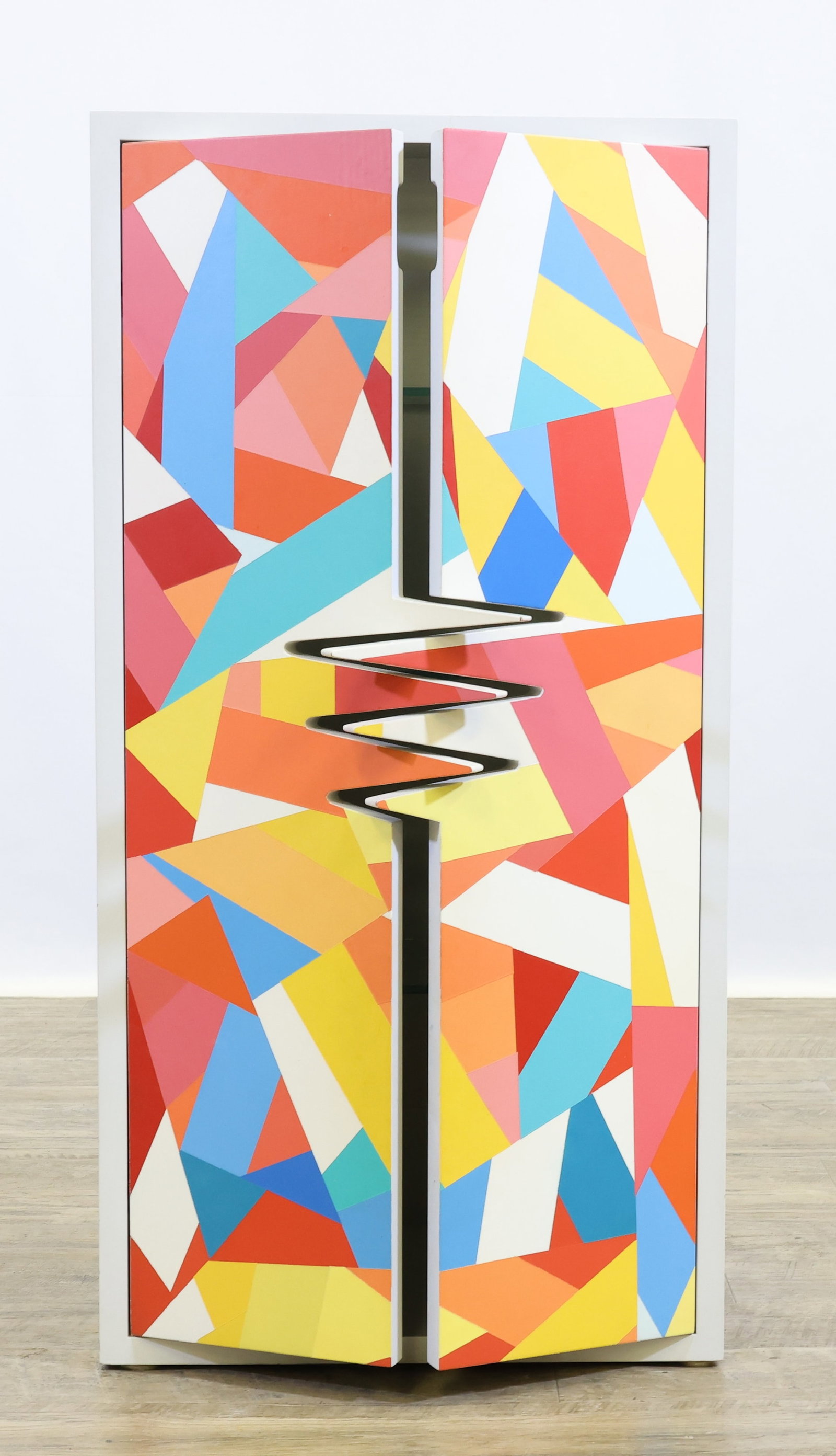 Dennis Will (20th/21st c.): Contemporary white cabinet with magnetic door closure and interior fitted with three glass shelves. Door fronts are a collaged of wide strips of vibrant colors, closing edges have unique jagged