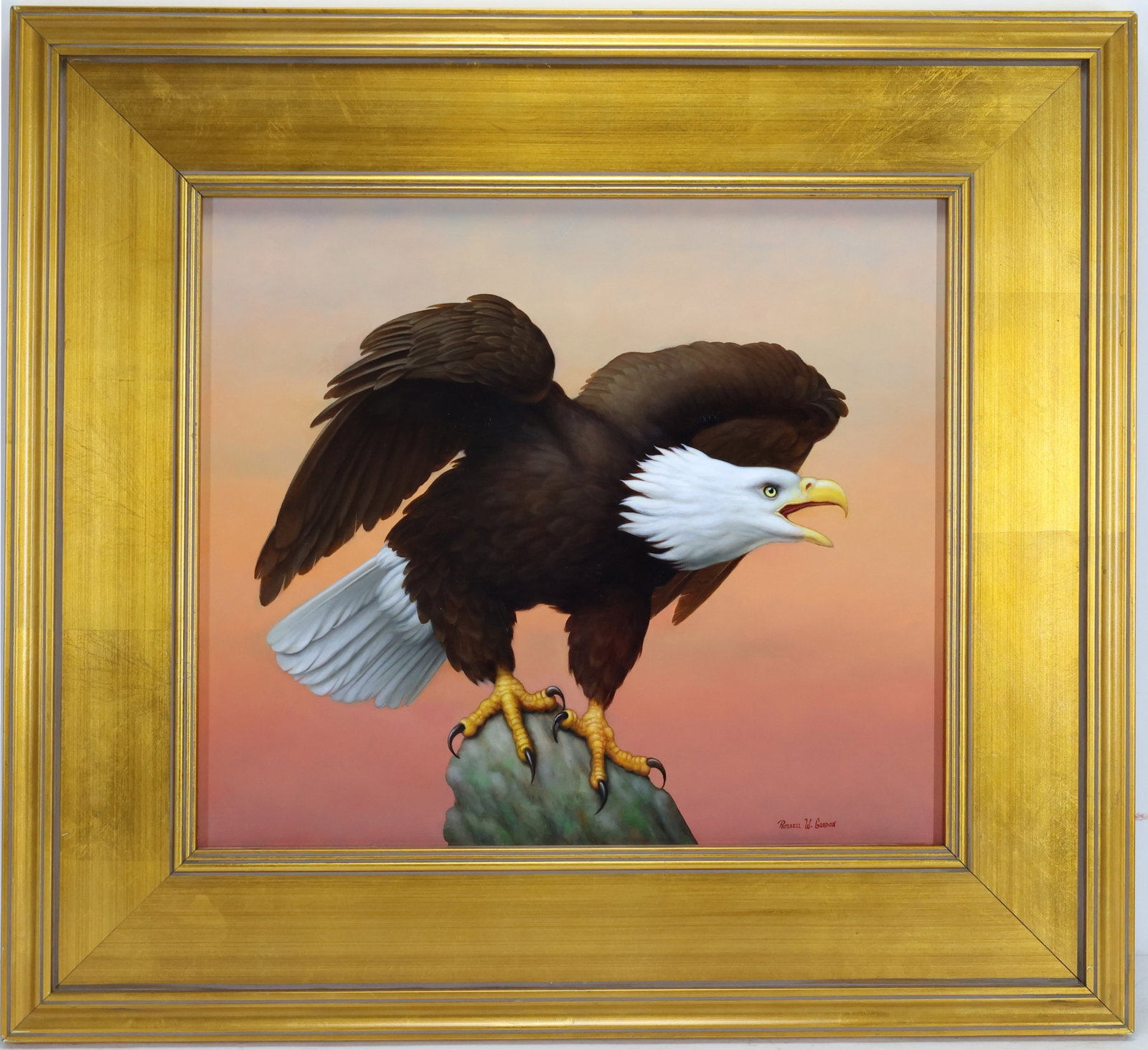 Russell Gordon (Born 1968): Oil on canvas, SLR. Realist wildlife portrait with a bald eagle perched on a rock with wings raised. 15"h x 17"w and 22.75"h x 24.75"w framed.