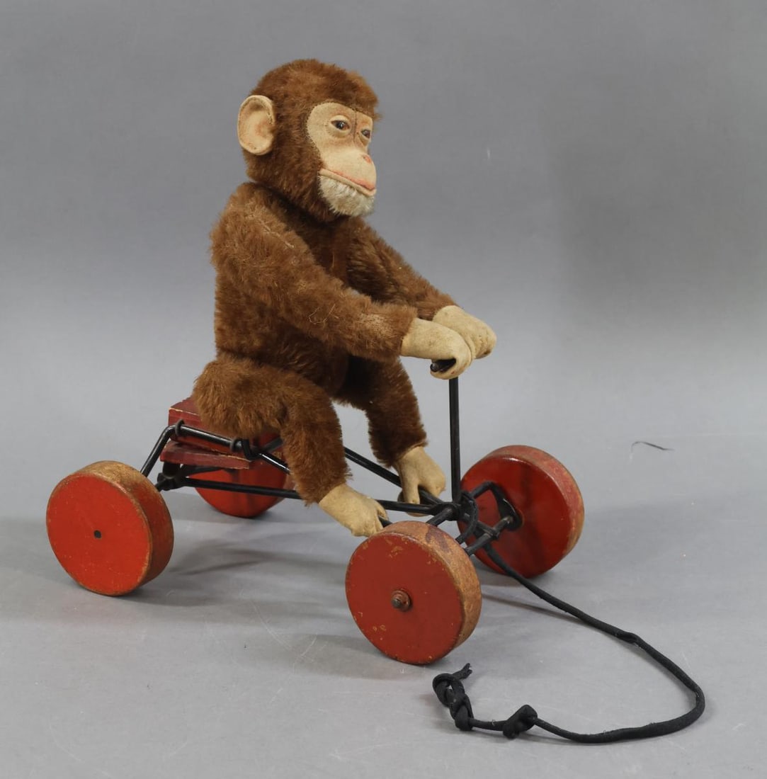 VINTAGE STEIFF.: 10" T x 9" L x 5 1/2" W 1912-1925 "Record Peter" Monkey. Brown mohair plush substitute with camel felt face, ears, hands, feet. White mohair chin. Amber glass eyes. Jointed Monkey sitting on metal
