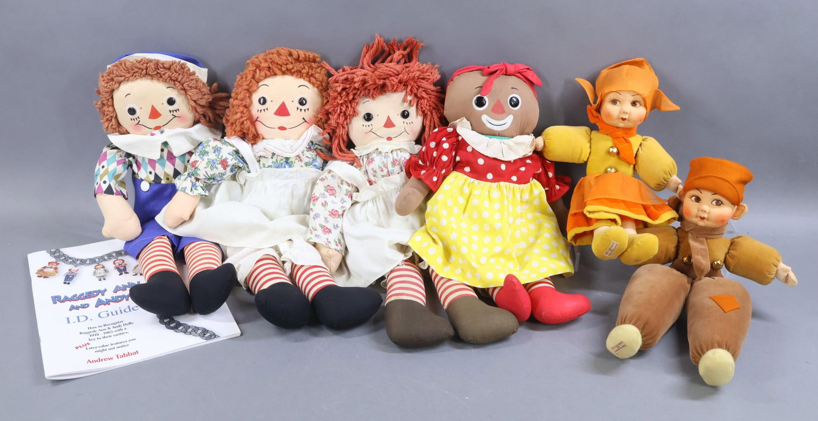 CLOTH DOLLS.: LOT. RAGGEDY ANN FAMILY. (3) Tagged Georgene Novelties - 18" Raggedy Ann. 19" Raggedy Ann and Andy. 20" Raggedy Ann. (Look at the difference in the faces.) Tagged 16" Knickerbocker "Beloved Belindy".