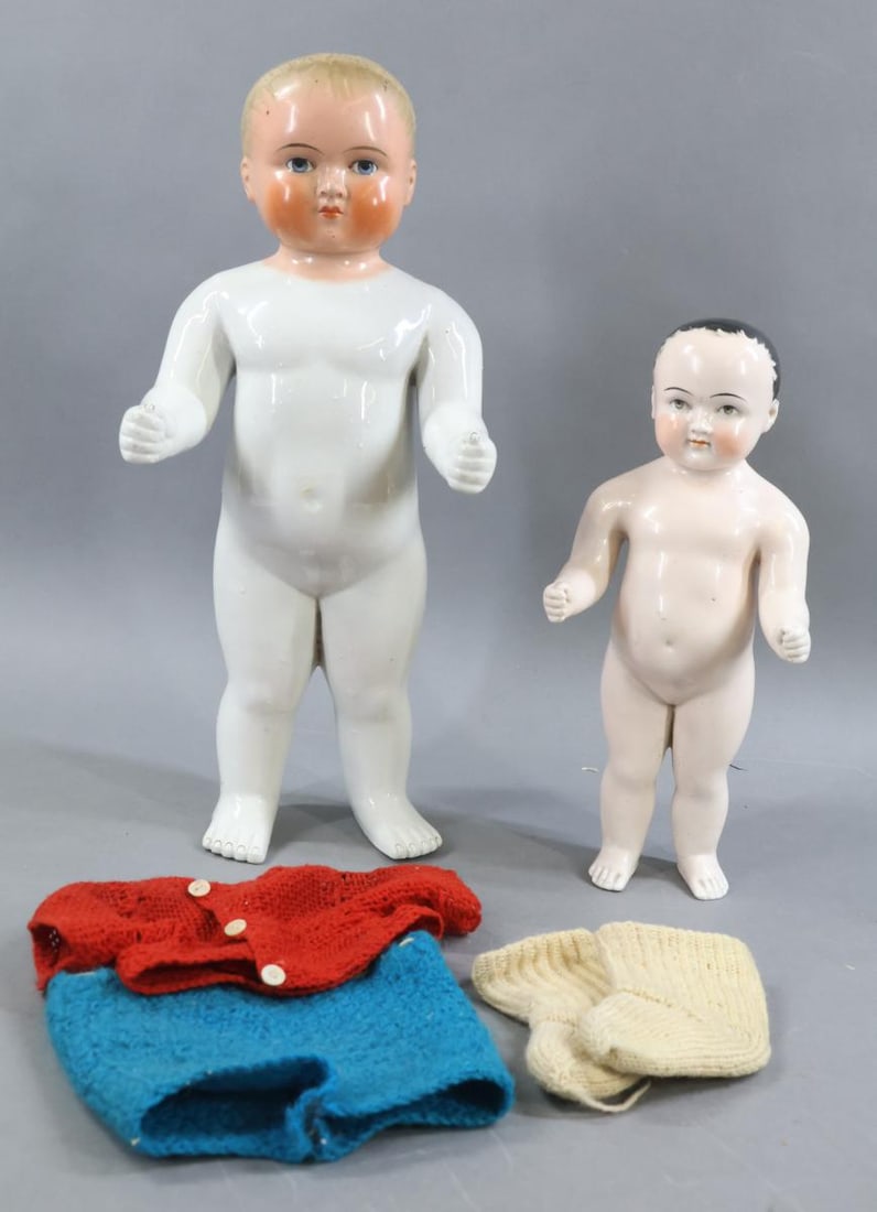 CHINA DOLLS.: Pair of China Bathing dolls. Doll 1) 11 1/2" has a pink tint body, painted black hair, grey eyes. Doll 2) 16" has a painted head with blonde hair, blue eyes. (He came dressed in knit outfit. Clothing