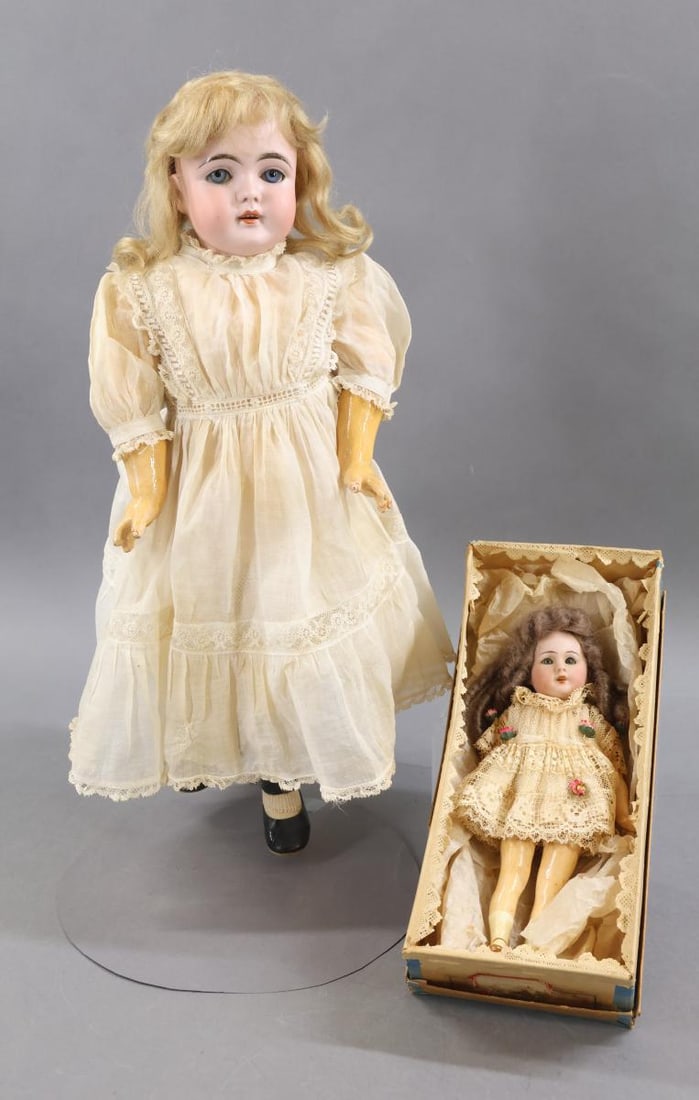 GERMAN BISQUE DOLLS.: Pair of dolls. Both dolls have blue sleep eyes, open mouths, mohair wigs, papier mache bodies and are dressed in all antique white cotton clothing. Doll 1) 17" C 1/2 MADE IN GERMANY 7 1/2 143. Blonde