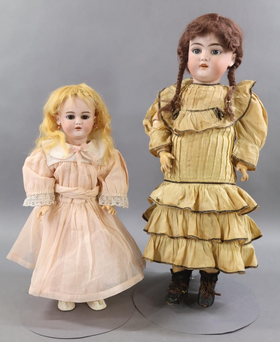GERMAN BISQUE DOLLS.: Pair of dolls. Both dolls have sleep eyes, pierced ears, open mouths, mohair wigs, papier mache ball jointed bodies. They are wearing vintage/antique clothing. Doll 1) 21" SH 1079-8 1/2 DEP GERMANY
