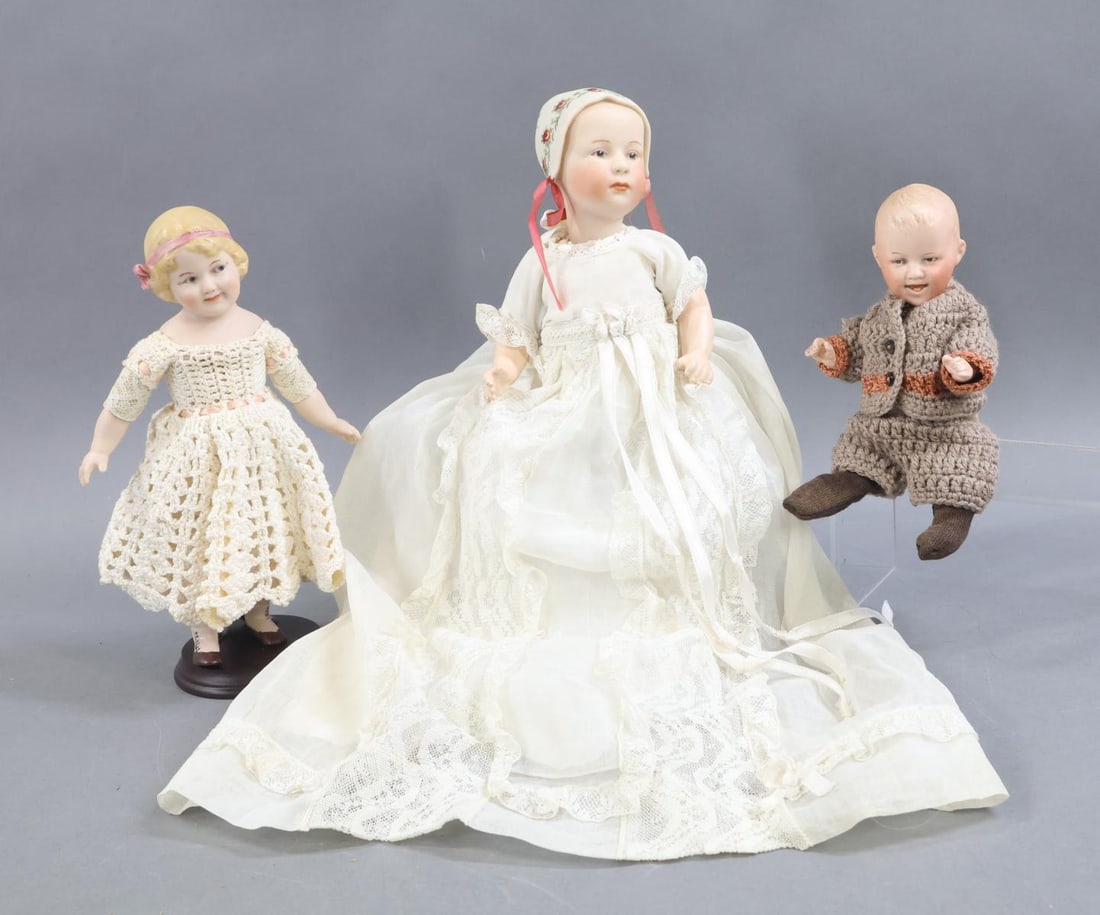 GERMAN BISQUE CHARACTER DOLLS.: LOT of (3) GEBRUDER HEUBACH dolls. All of the dolls have intaglio eyes and are dressed in vintage/antique clothing. ANTIQUE - Doll 1) 7" 6897 "Laughing Heubach" with brown eyes, open/closed mouth. 5