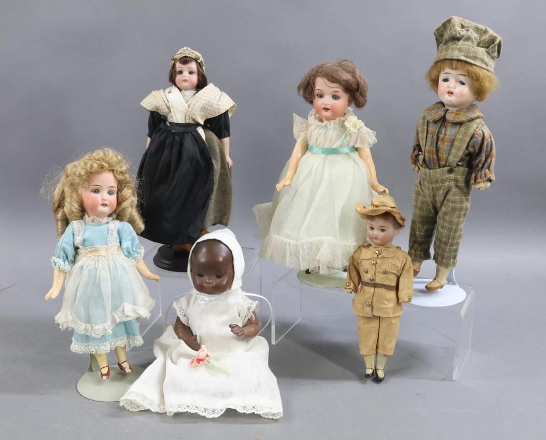 GERMAN BISQUE DOLLS, 12" UNDER.: LOT of (6) dolls. (4) Dolls have 5 pc, papier mache bodies. (4) Have painted shoes. 7", (2) 8", (2) 9.". (2) Have stationary and (3) have sleep eyes. They are dressed in vintage/antique clothing.