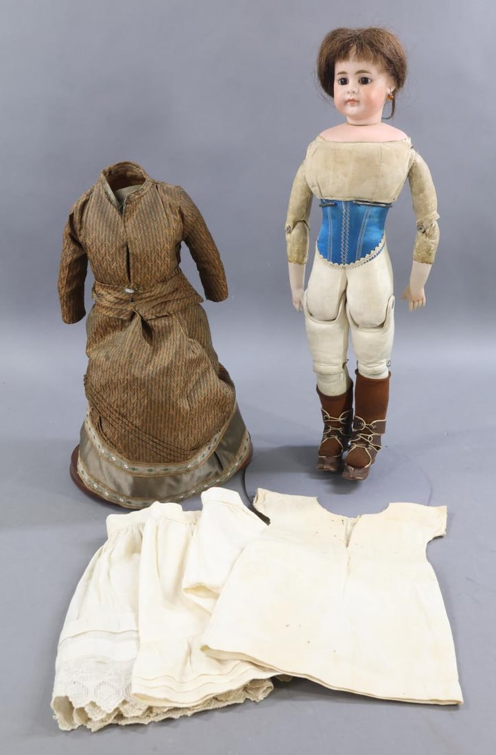 GERMAN BISQUE CLOSED MOUTH DOLLS.: 18 1/2" 51/8 Solid dome Belton style doll with socket head on a separate bisque shoulder plate. Stationary brown eyes, closed mouth, pierced ears, brown HH wig. Leather fully pin jointed body at