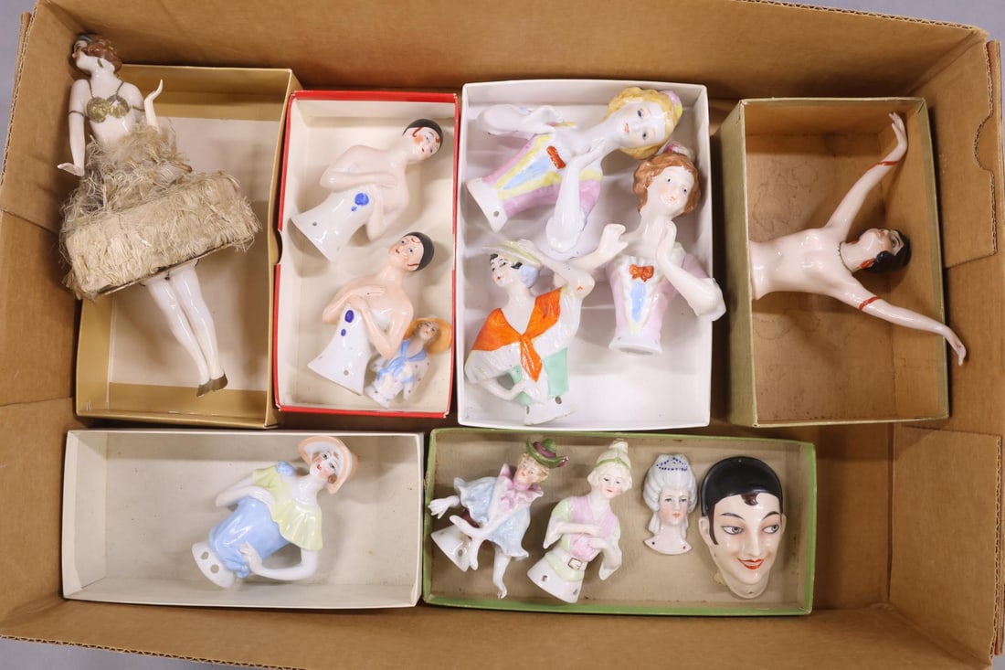 CHINA DOLLS.: LOT of (11) China HALF DOLLS and (2) China FACES. Dolls - 2 1/4" - 5". All but (2) are marked GERMANY. 4" Doll has her arms extended away from her body. 7 1/2" Flapper doll mounted on a CANDY BOX and