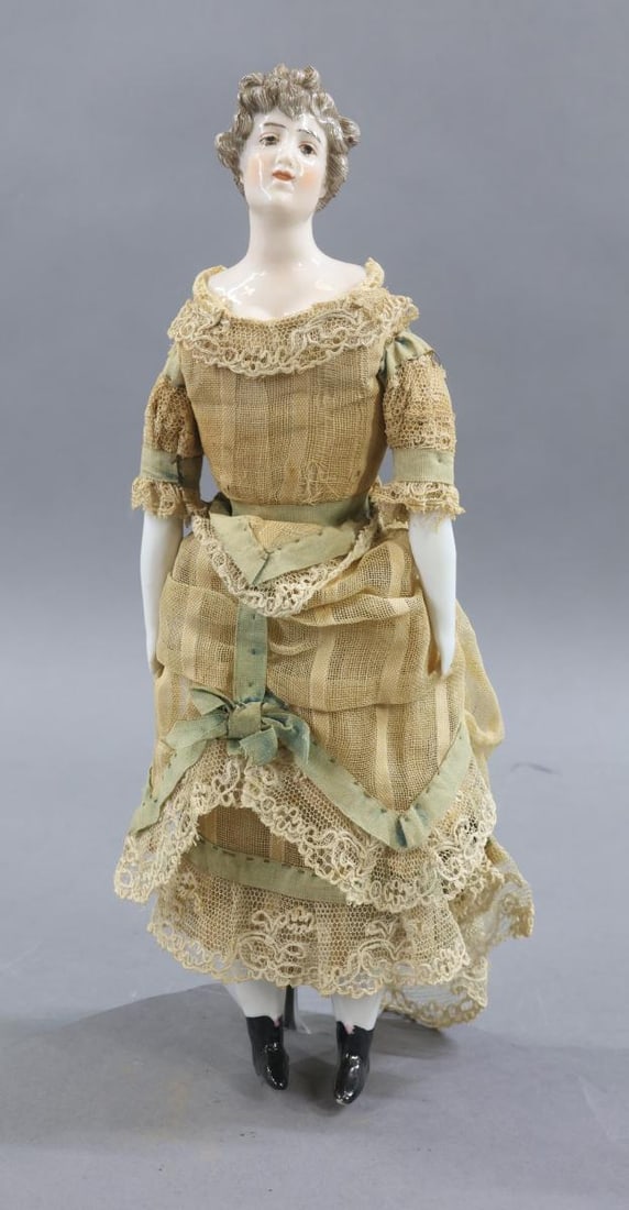 CHINA DOLLS.: 11" DRESSEL & FISTLER turned shoulder head China doll with molded breastplate. Painted grey intaglio eyes, beautiful grey hair with curls around face, bun in back. Cloth body with china lower arms