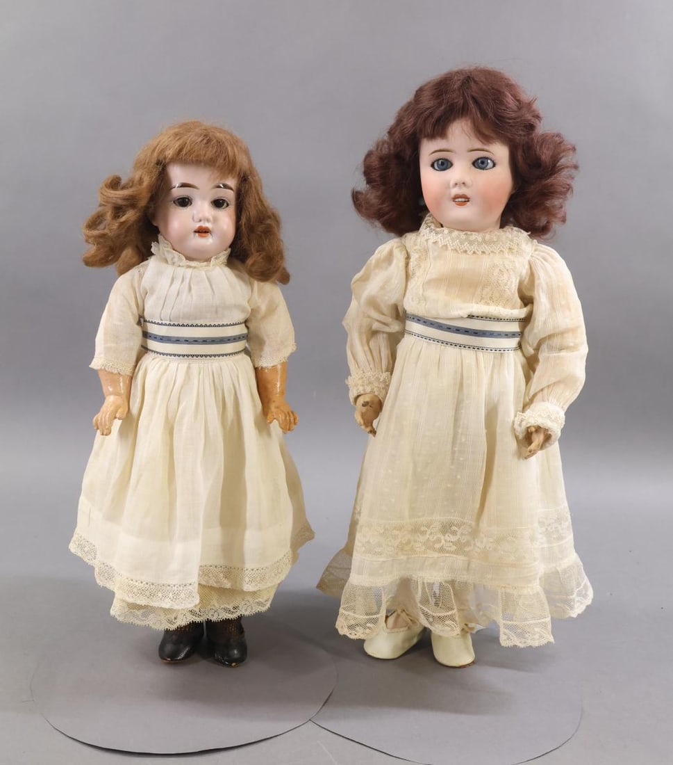 FRENCH/GERMAN BISQUE DOLLS.: Pair of dolls. Both dolls have sleep eyes, open mouths, brown mohair wigs, papier mache jointed bodies and are dressed in antique white cotton clothing with matching silk ribbon sashes. FRENCH - 16"