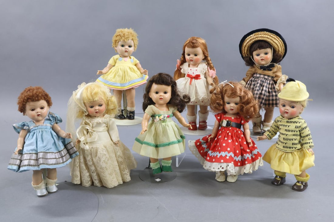 1940's - 1960's DOLLS.: LOT of (8) VOGUE 8" "Ginny" dolls. All of these are the 1950-1953 strung dolls with painted eyelashes. (2) Have the poodle cut Caracul wigs. All of them are dressed in original outfits. (7) Have the