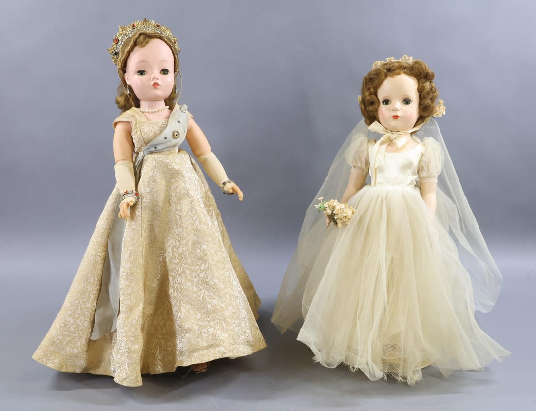 1940's - 1960's DOLLS.: Pair of MADAME ALEXANDER dolls. Doll 1) 20" CISSY 1958 "Queen Elizabeth II". HP doll with jointed knees, vinyl jointed arms, uncombed honey blonde wig. Original tagged gold gown with blue sash. Jewele